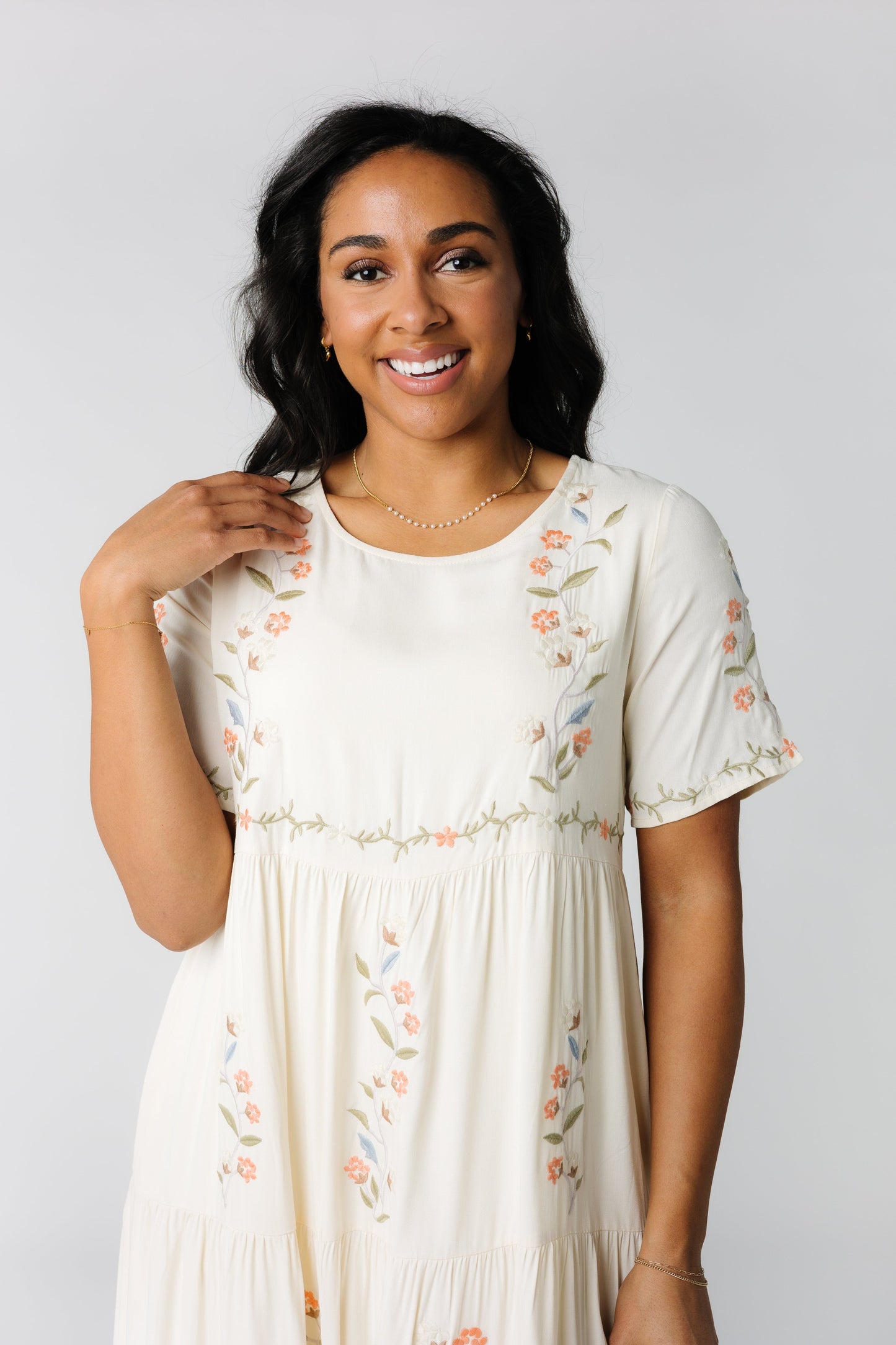 Close view of cream embroidered dress