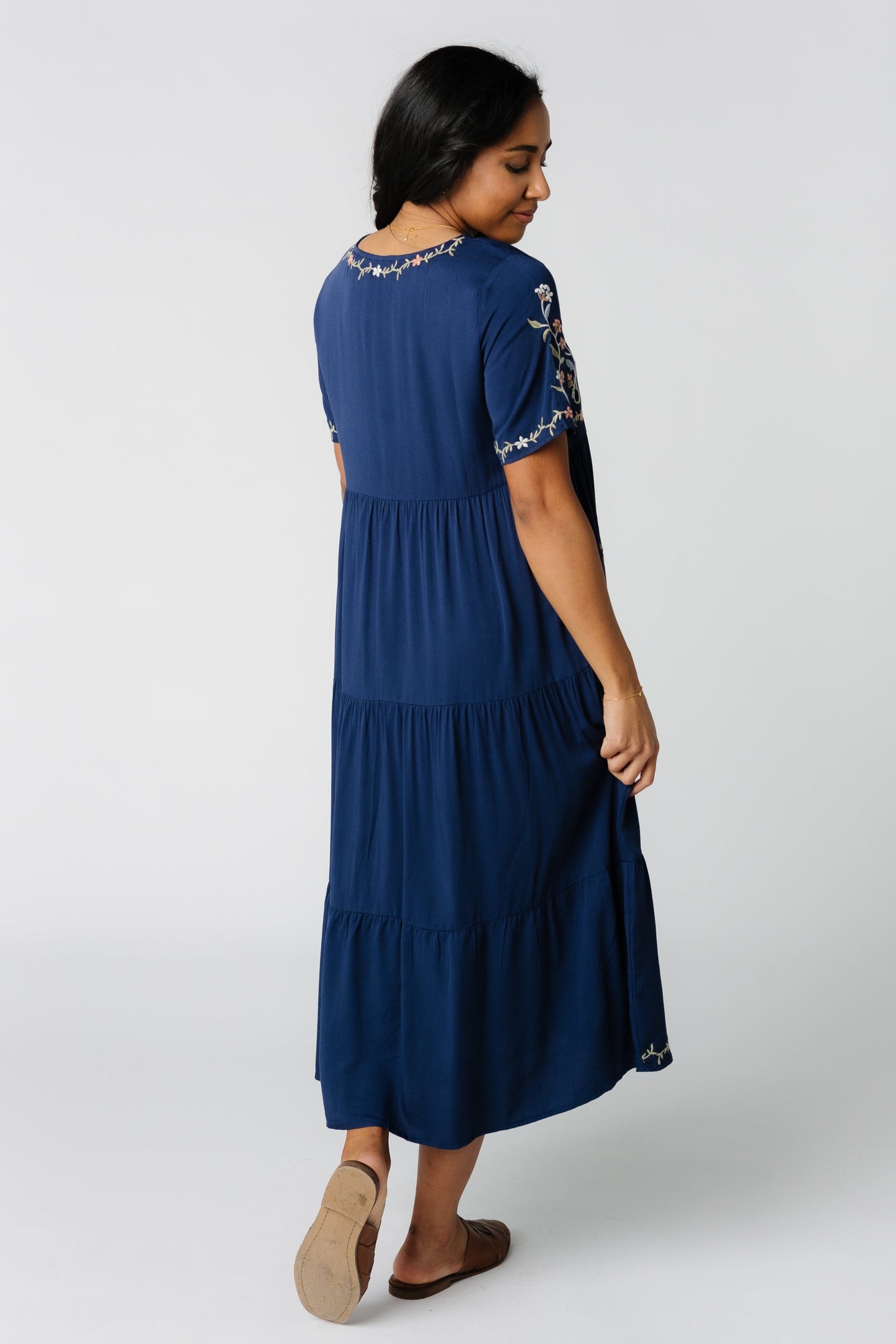 Back view of navy tiered midi