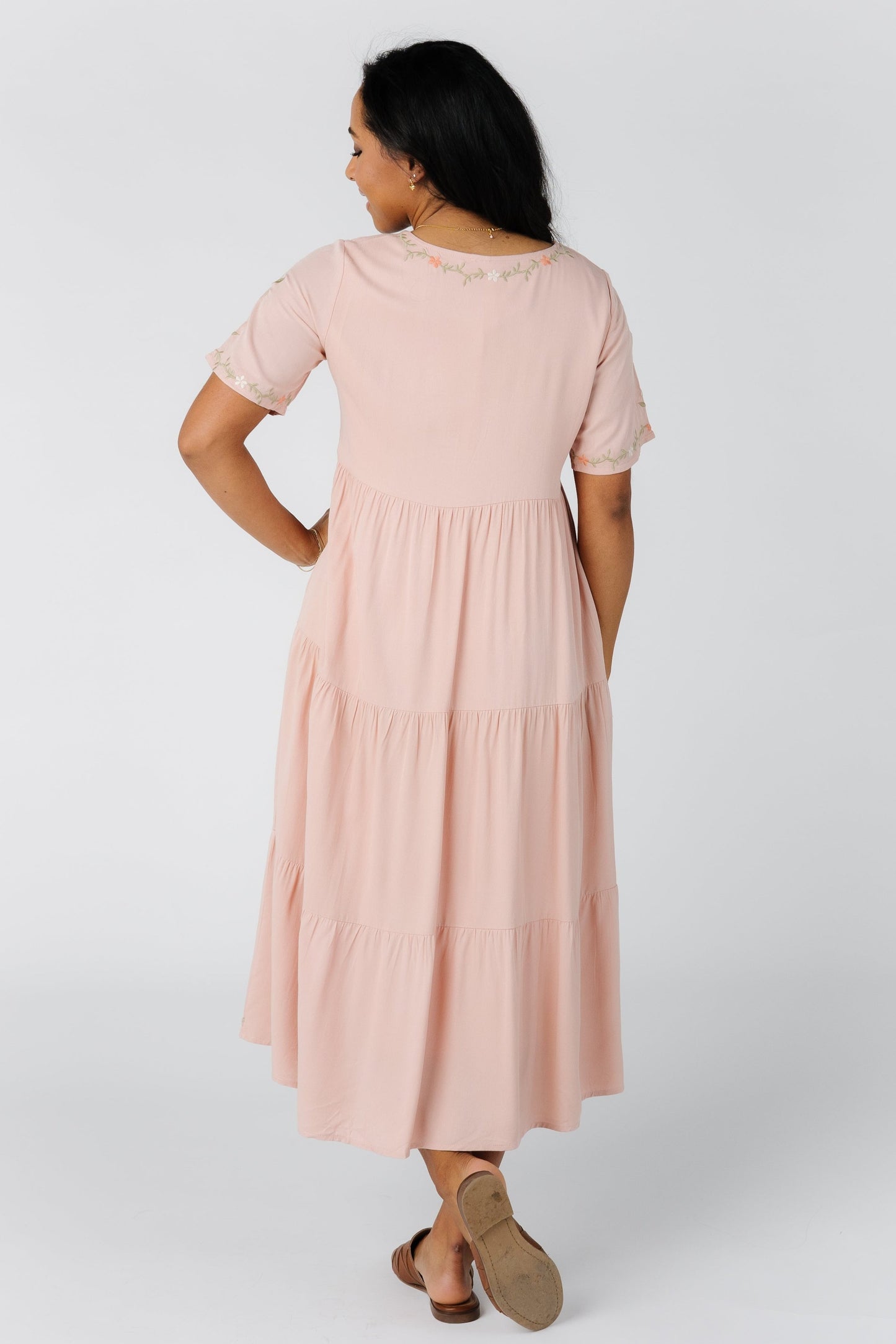 Back view of pink tiered midi with short sleeves
