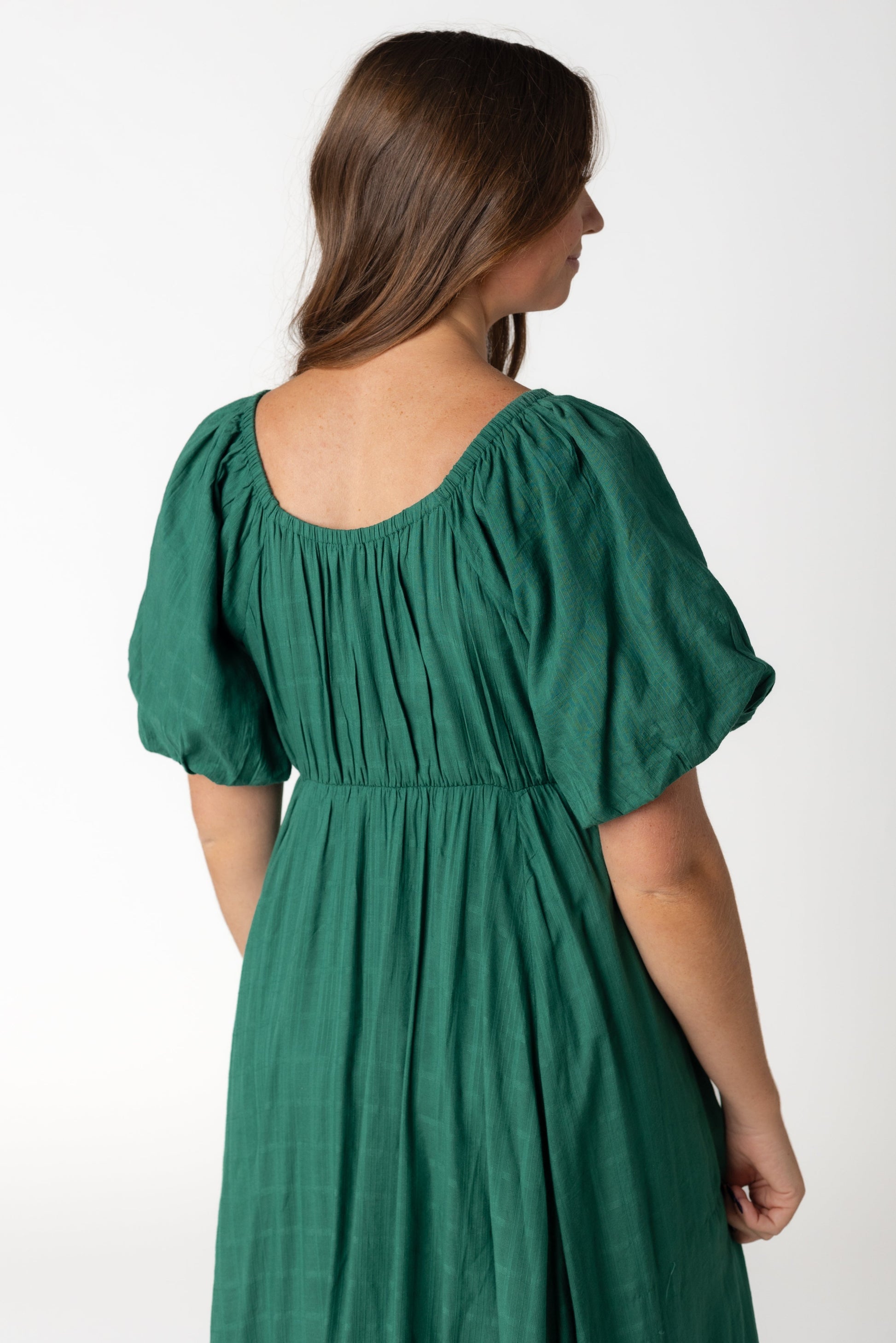 Back view of a woman in a green maxi with short sleeves