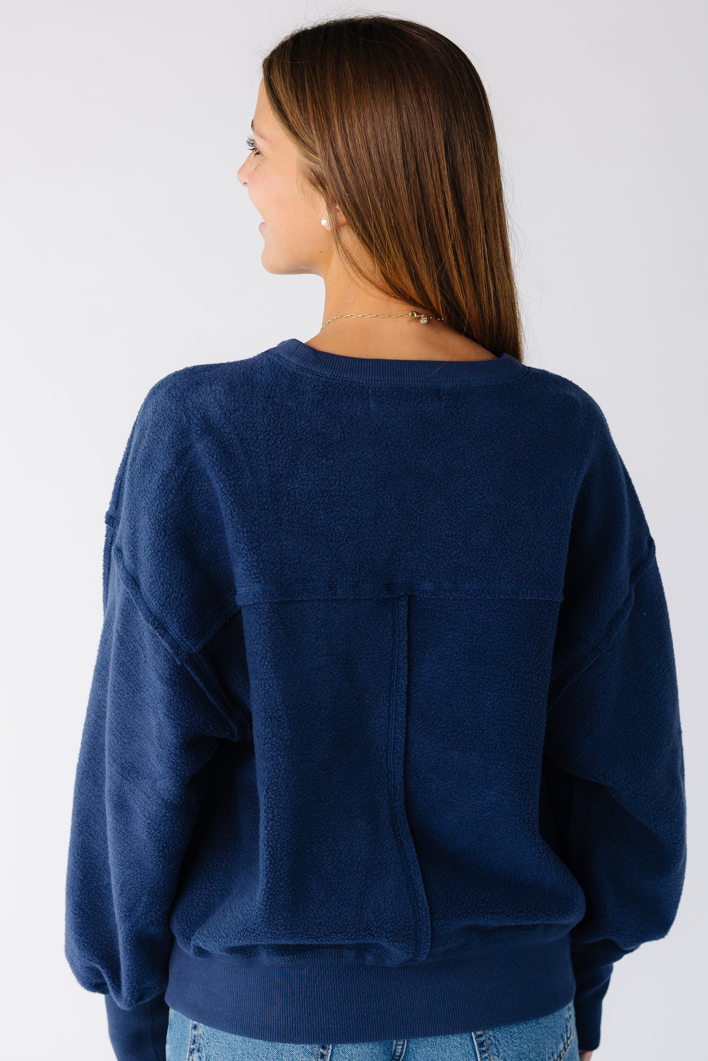 Woman wearing a reversible navy sweatshirt-sweater