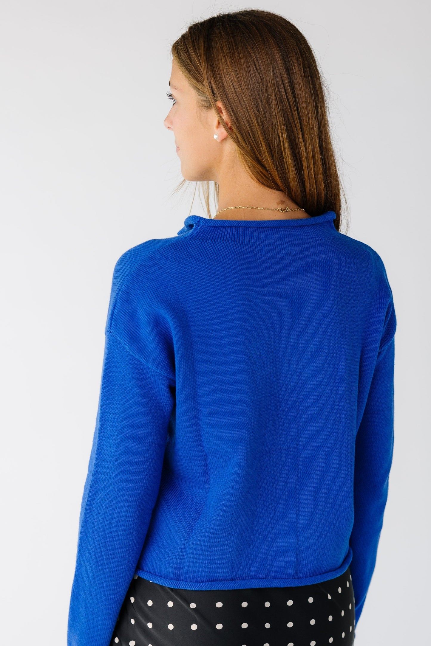 Back view of a women wearing blue long sleeve cardigan