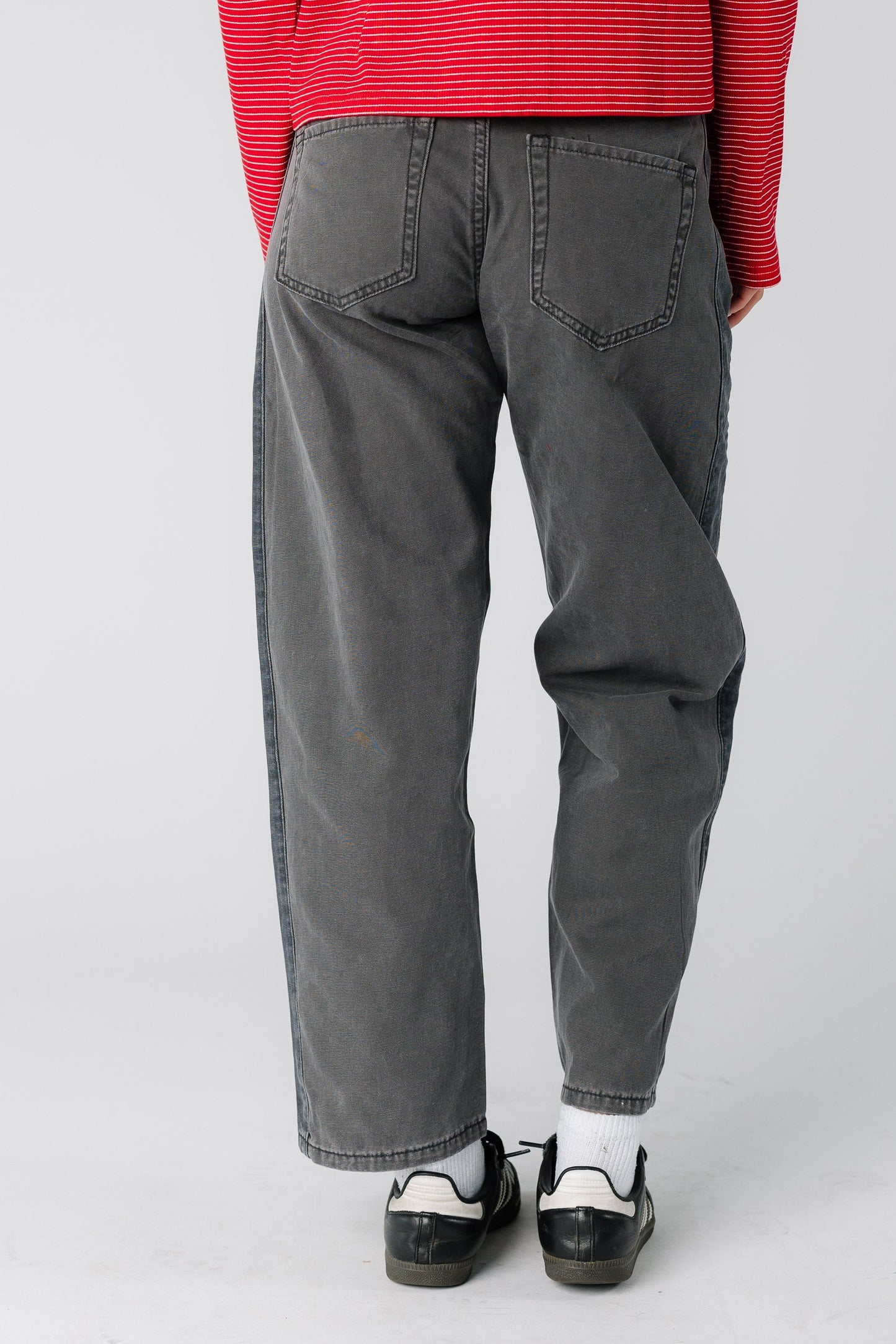 Woman wearing a pair of grey wide leg jeans