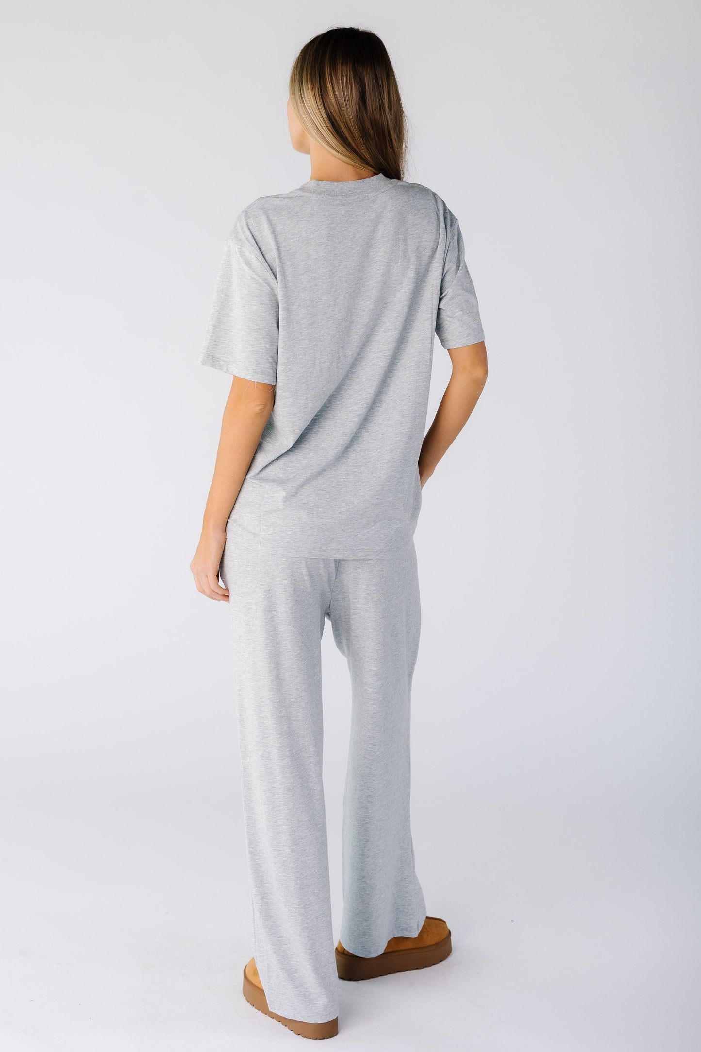 Back view of a woman wearing a short sleeve lounge set with long length pant