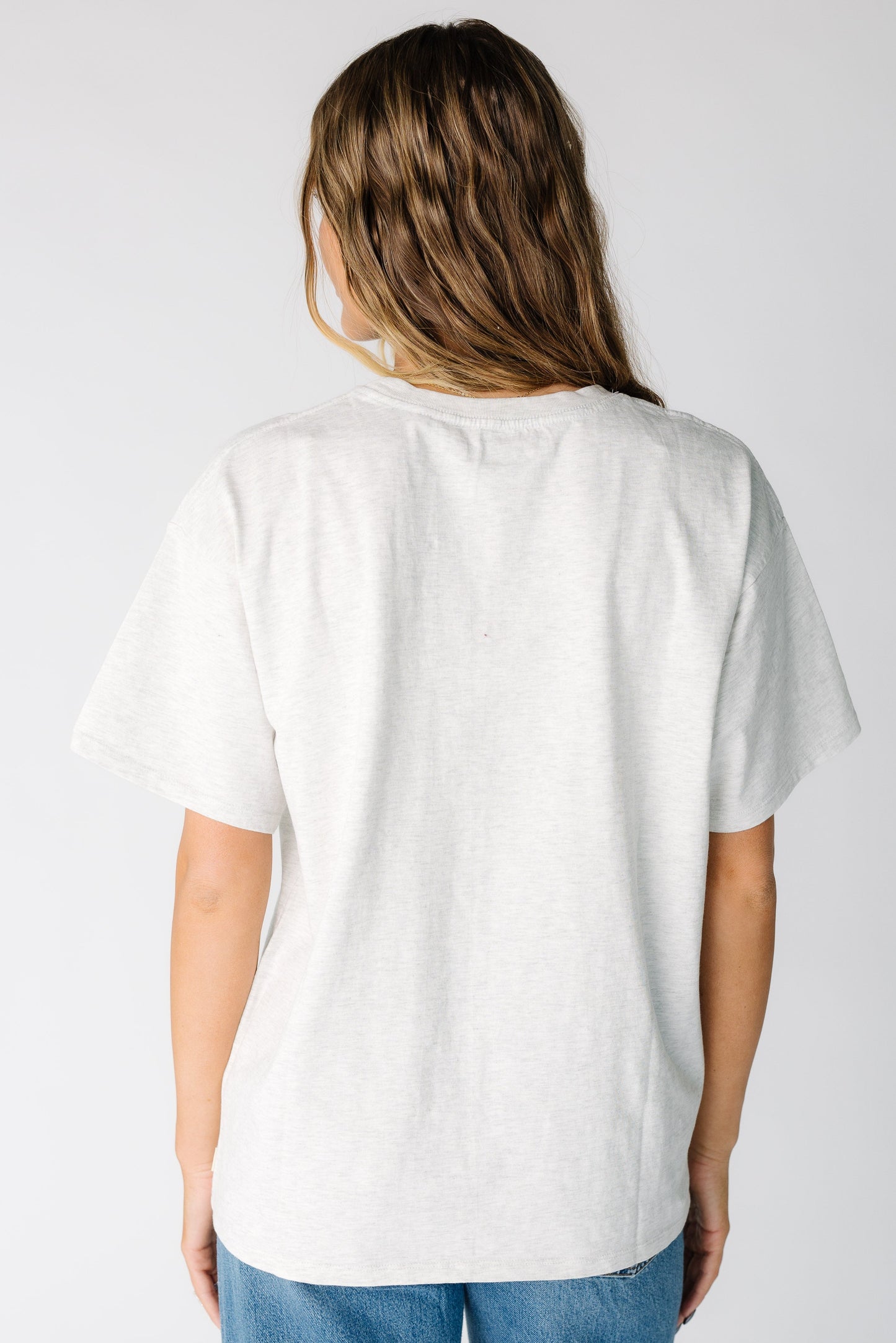 Back view of a woman wearing a light grey short sleeve tee