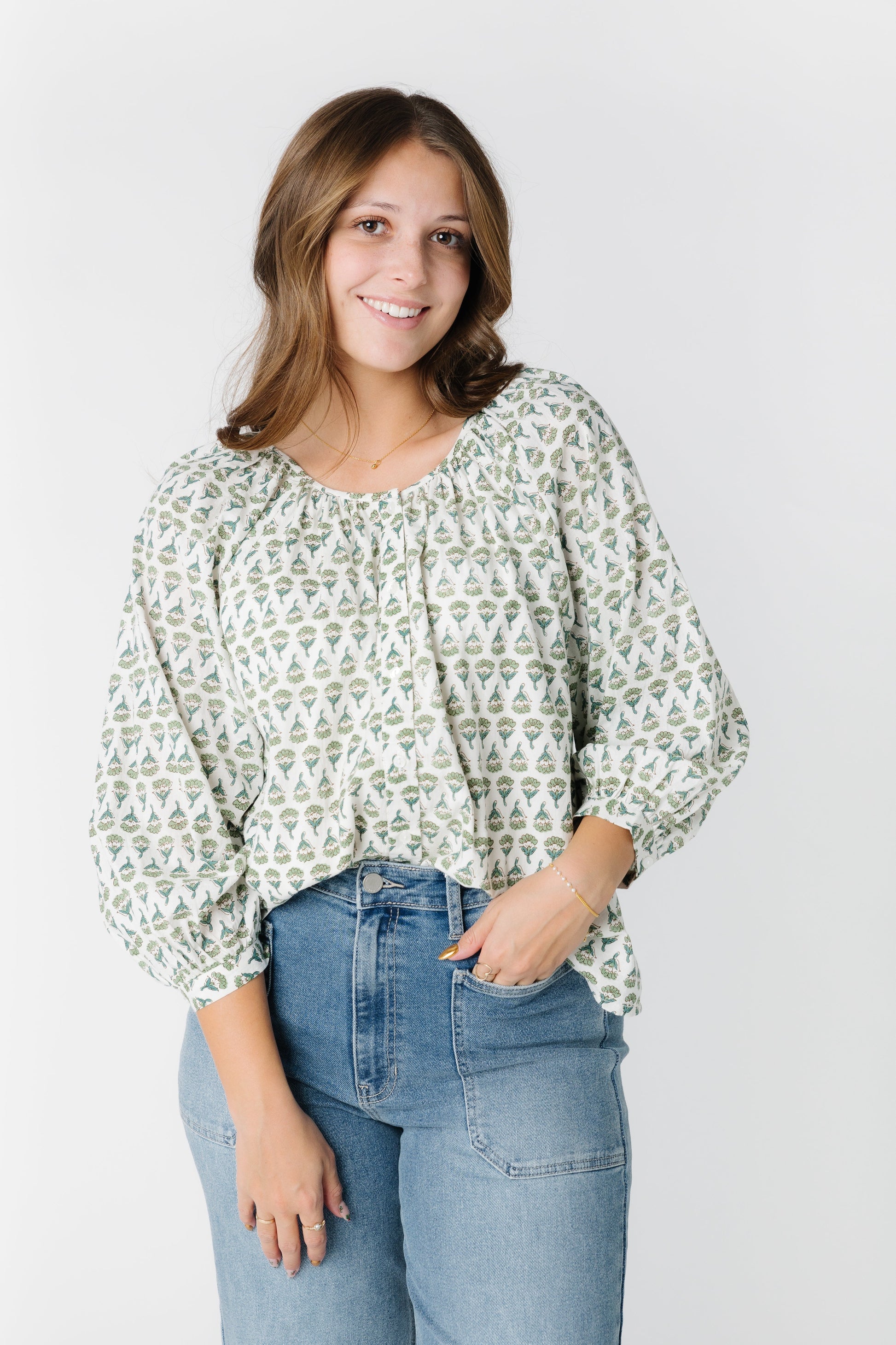 White print top with round neckline and three quarters sleeve