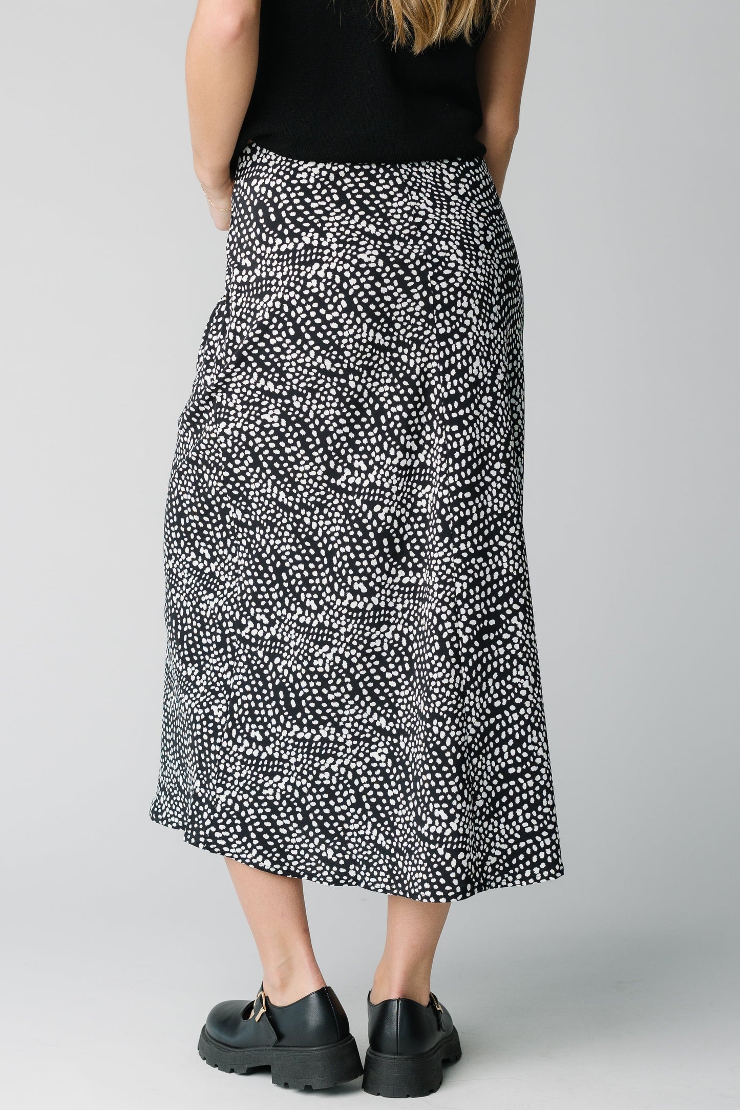 Back view of black and white patterned midi skirt