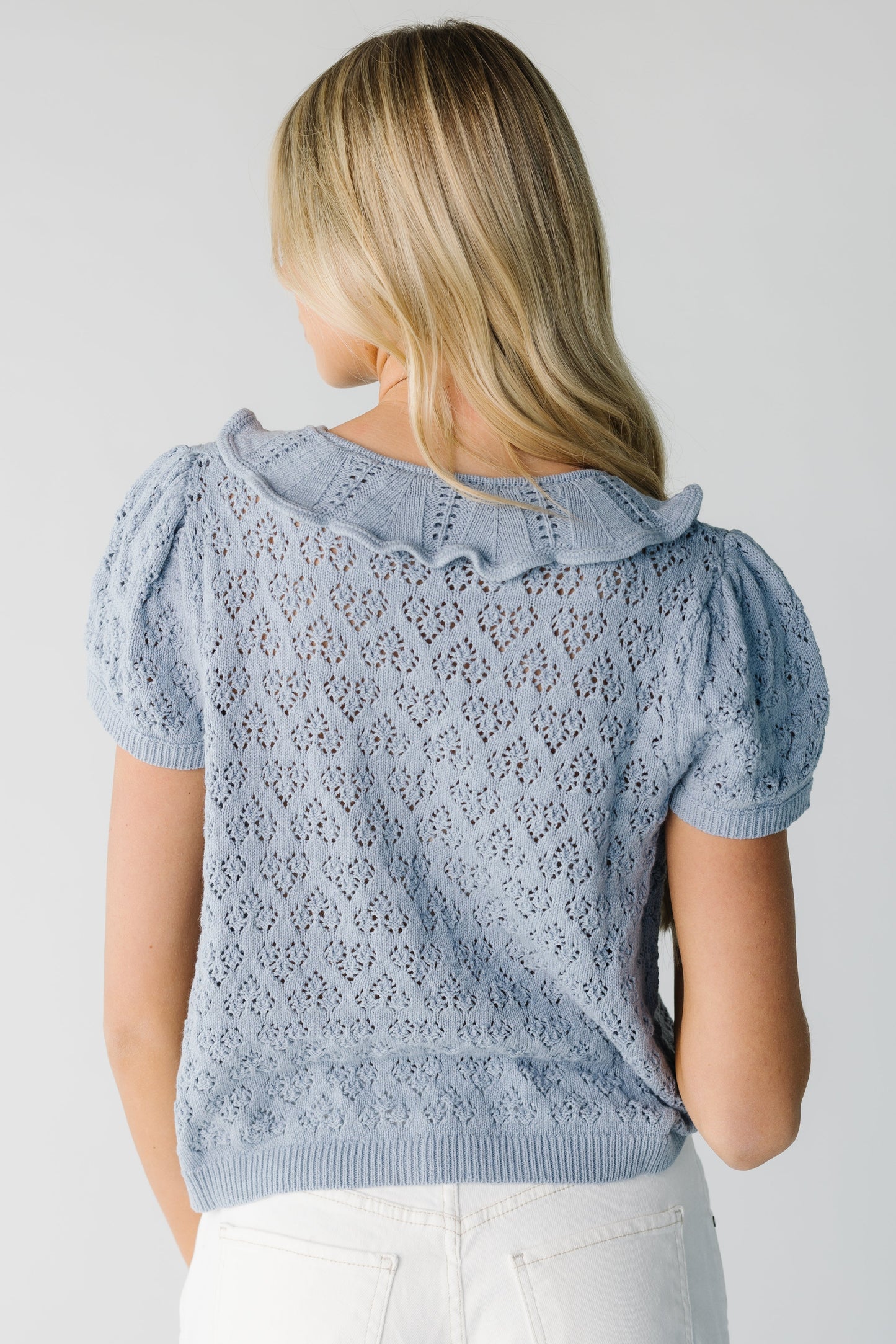 Back view of blue lace knit short sleeve cardigan