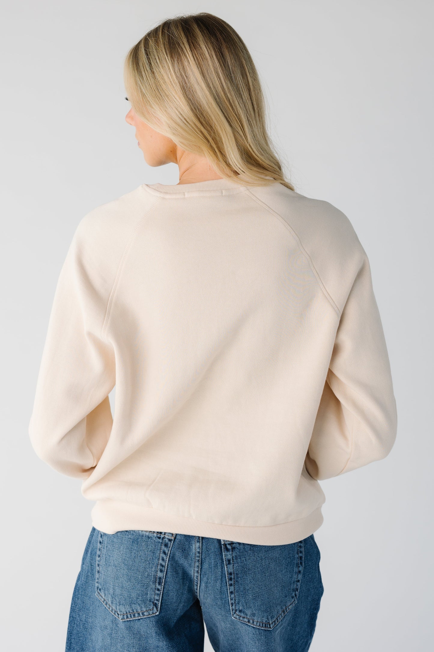 Back view of women wearing long sleeve sweatshirt