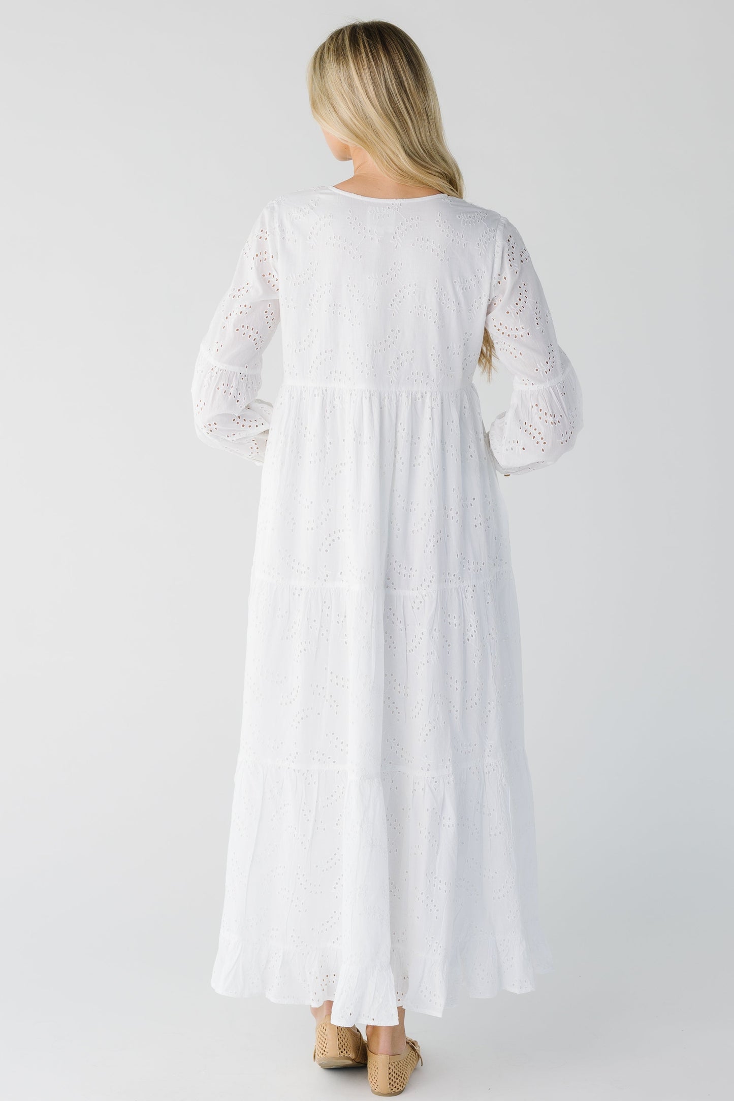 Back view of white eyelet long dress with long sleeves