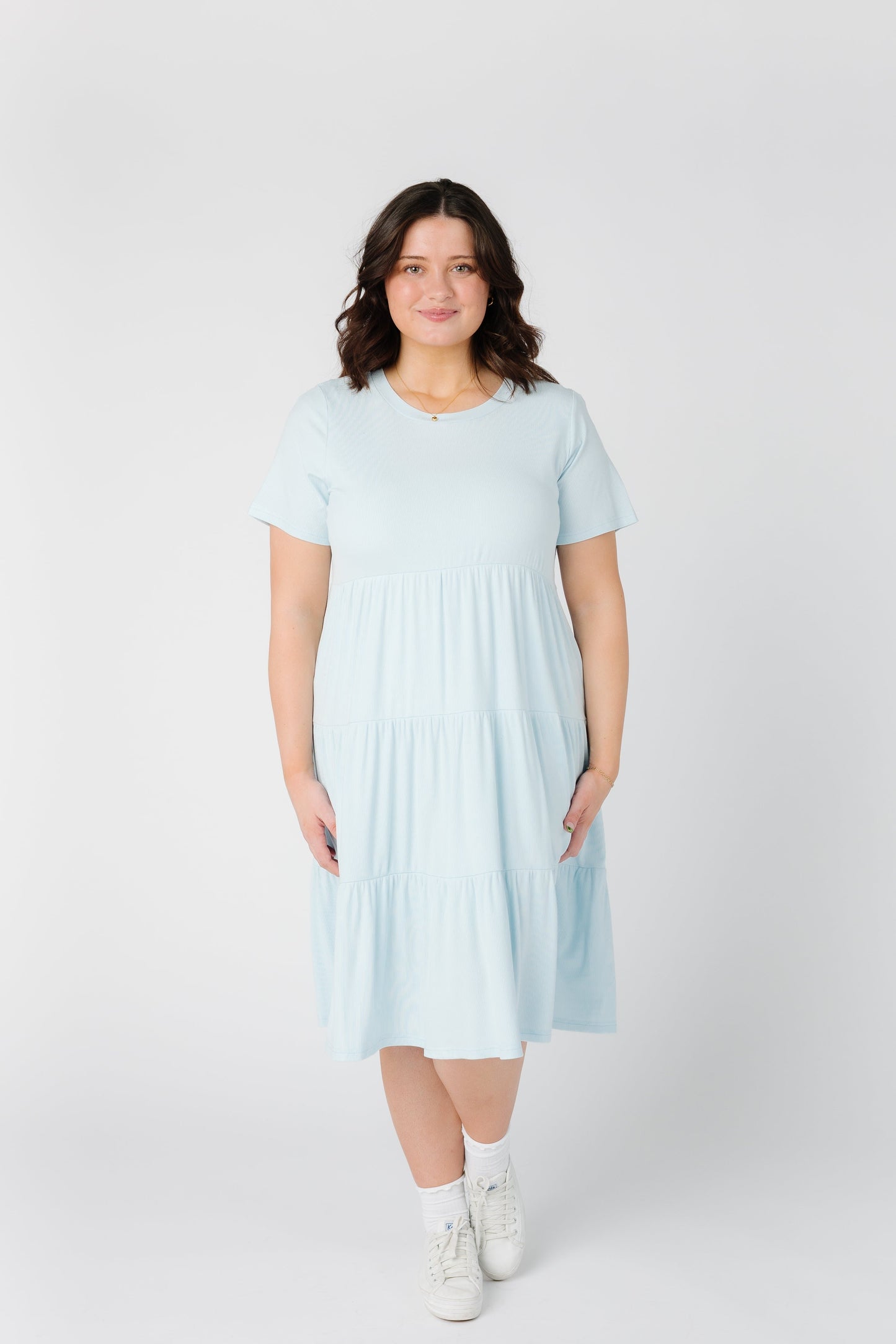 Woman wearing a modest plus size dress in light blue