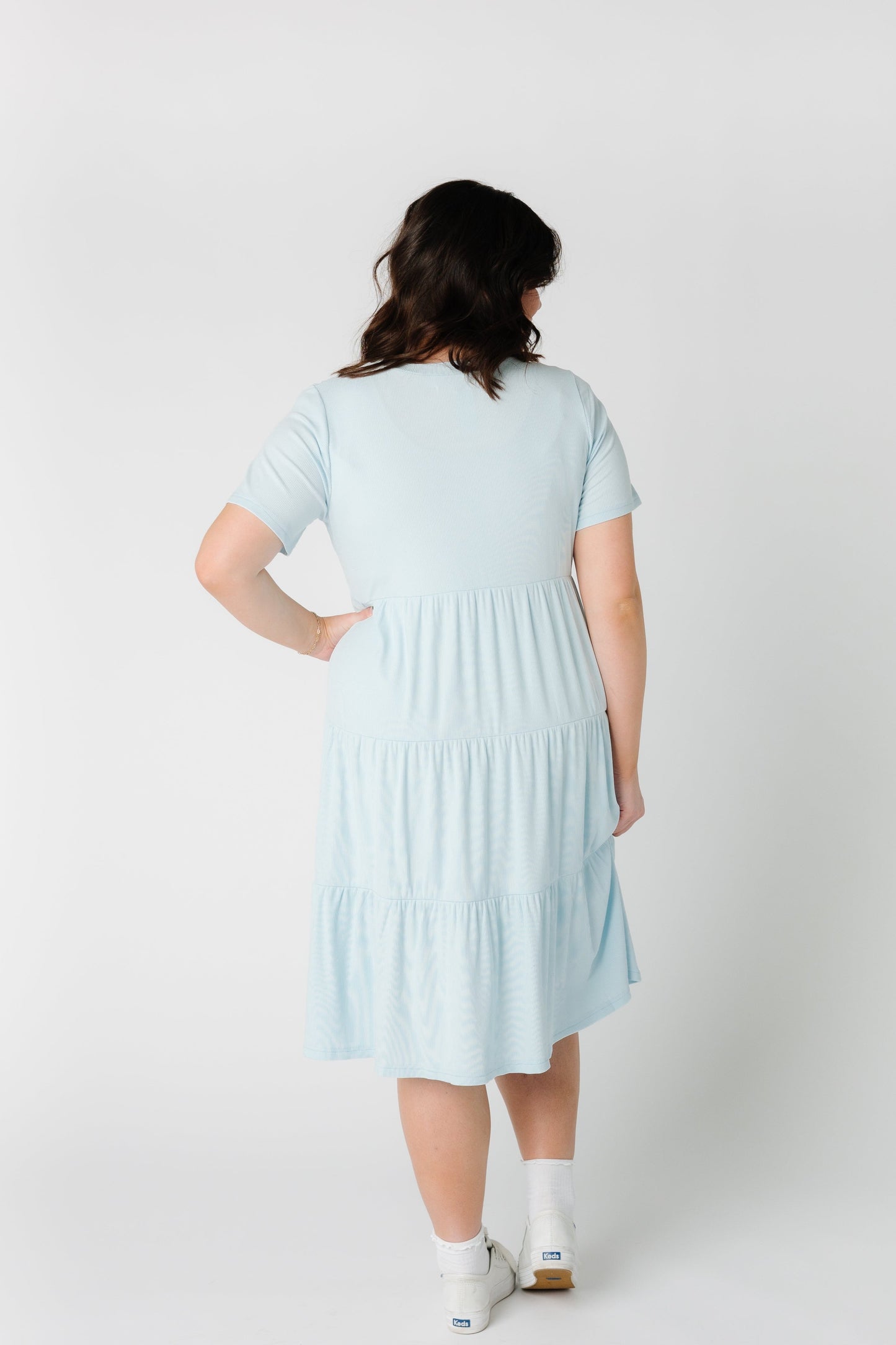 Another photo of a back view of a woman wearing a tiered dress