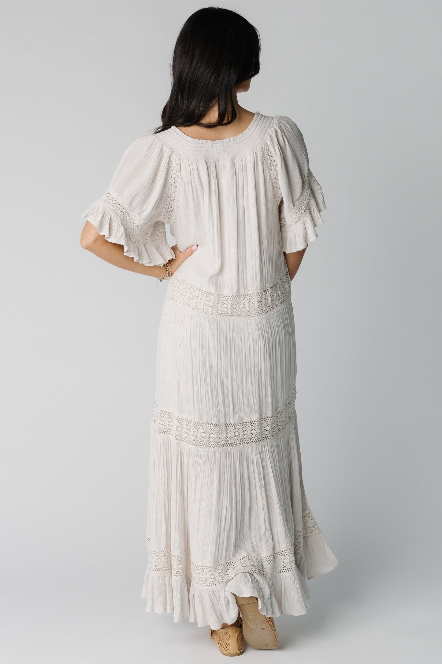 Back view of off white gathered tiered dress