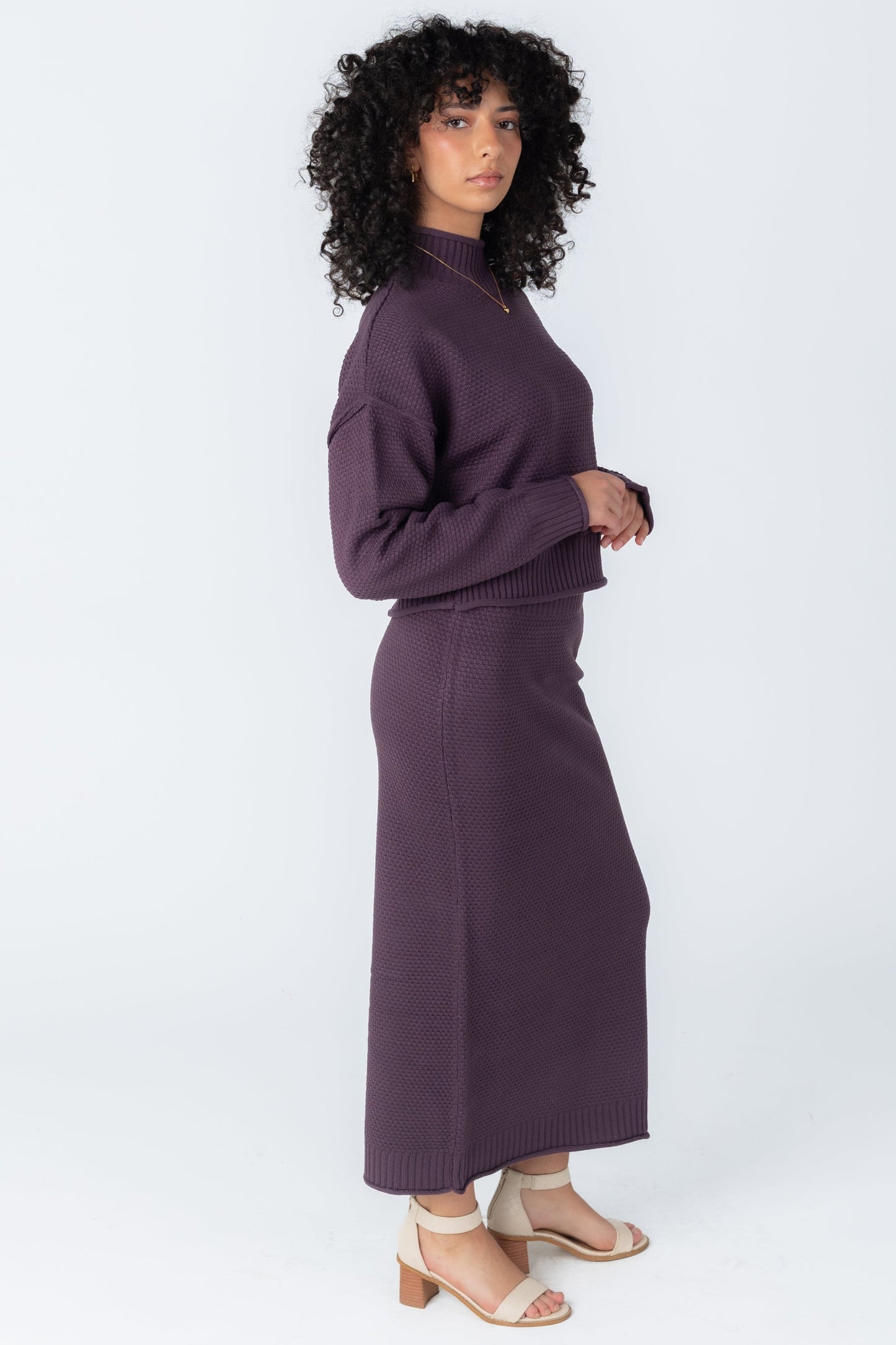Side view of plum 2 piece textured sweater and skirt set