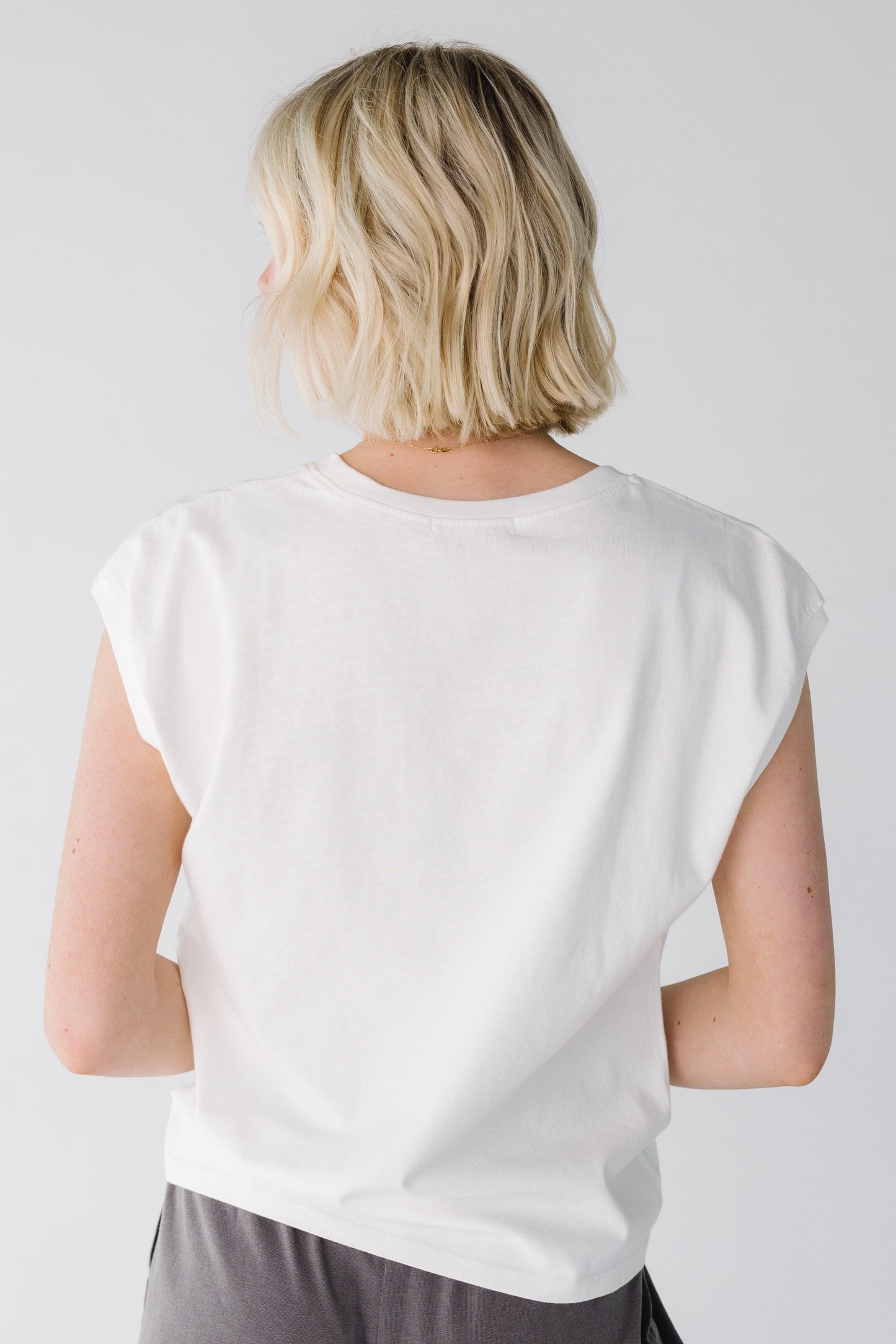 Back view of white crew neck top