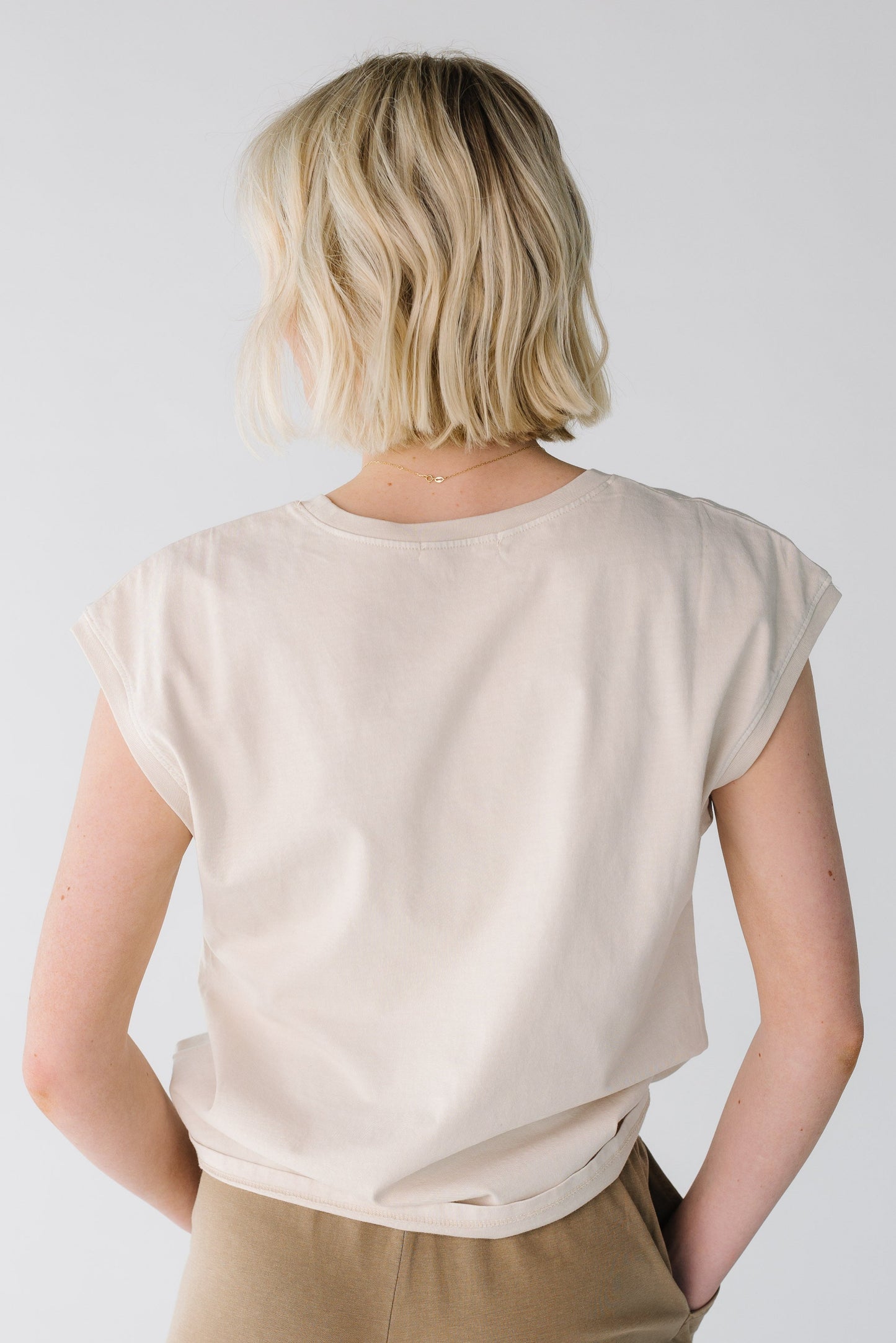 Back view of loose tee in light taupe