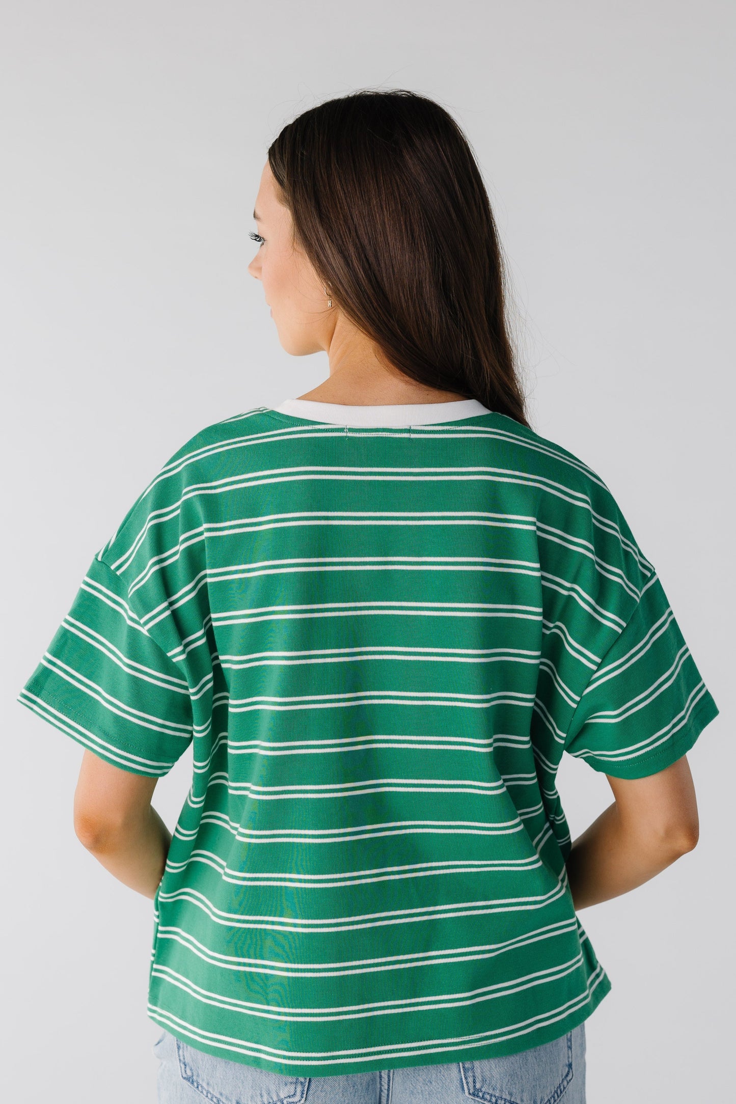 Back view of green and white stripe tee