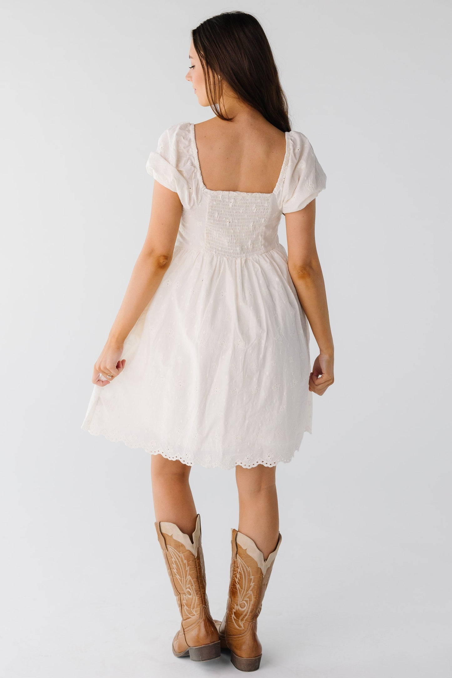 Back view of light eyelet dress with square back neckline