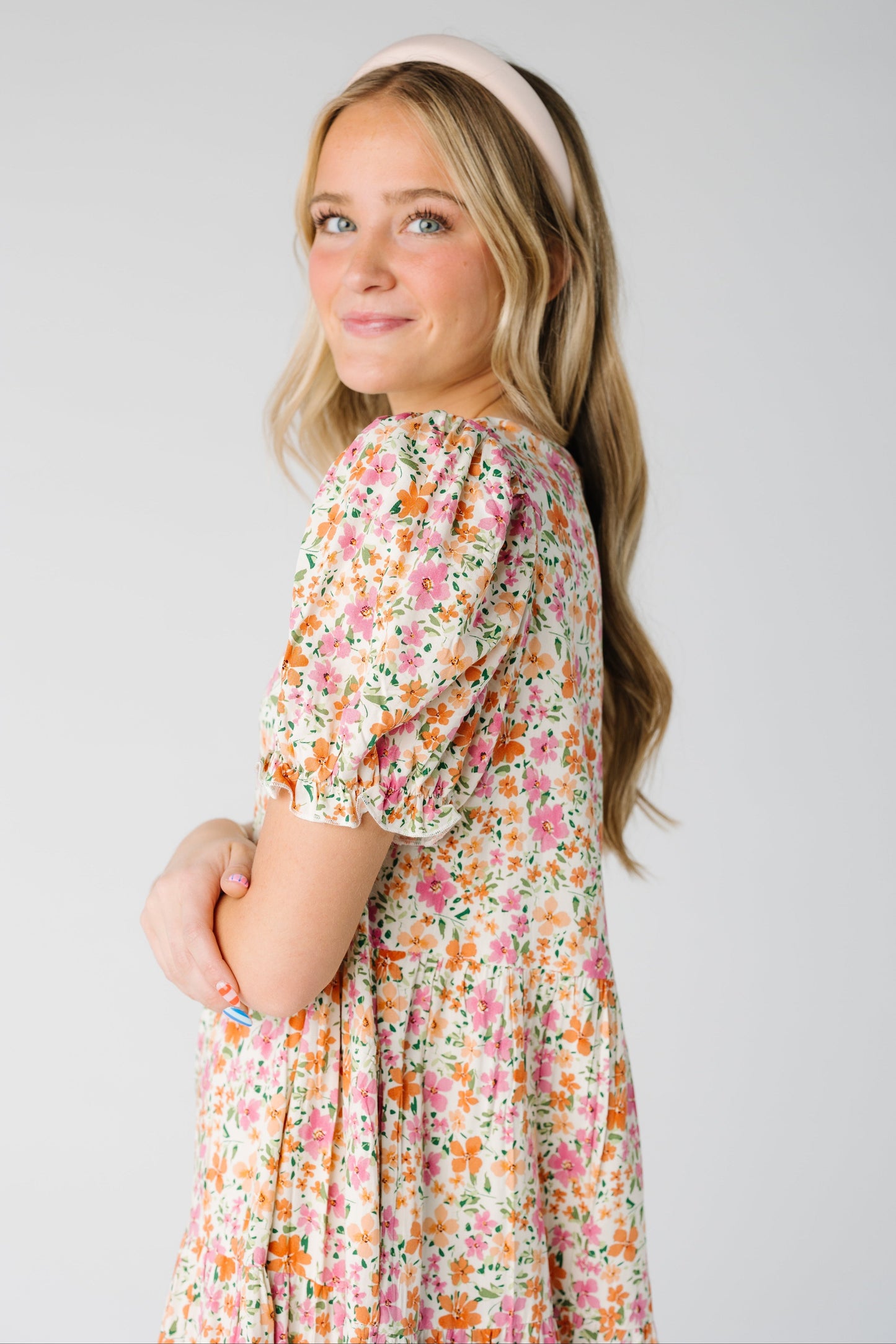 Close view of a woman wearing a pink floral gingham dress with short sleeves