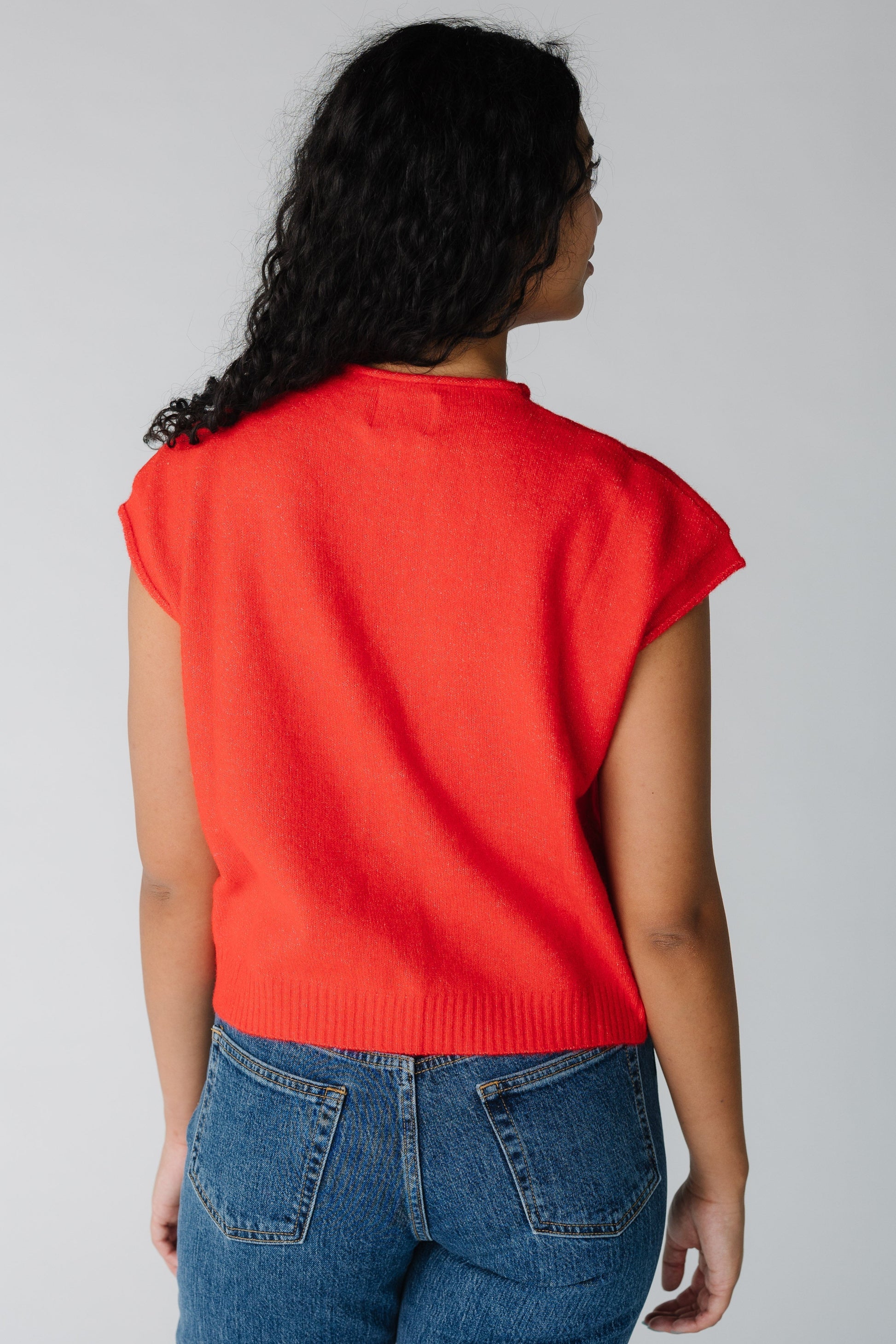 Back view of red sweater vest