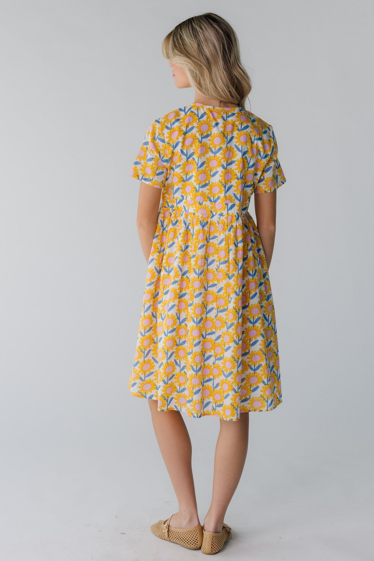 Back view of yellow floral short sleeve dress