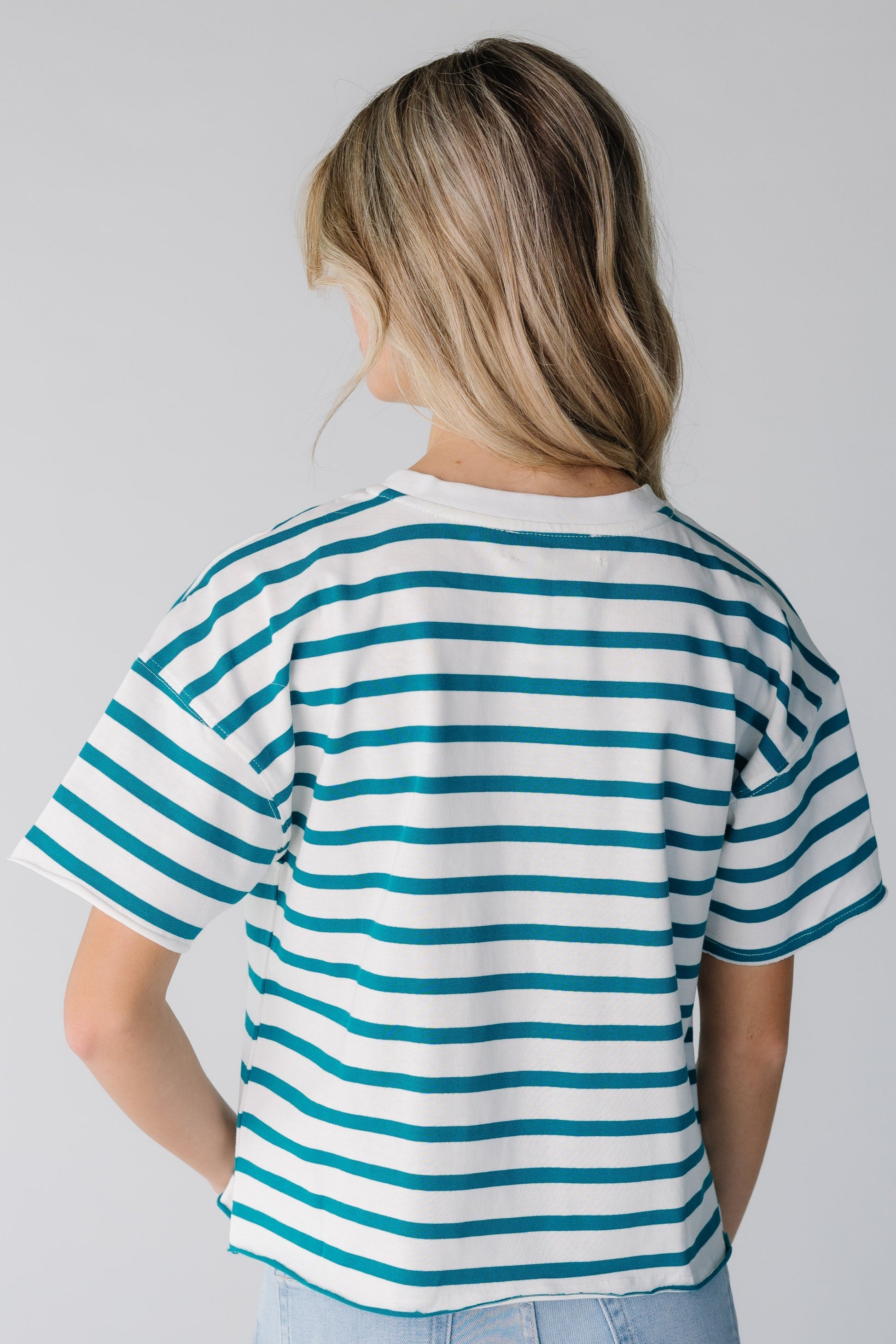 Back view of white and green stripe tee