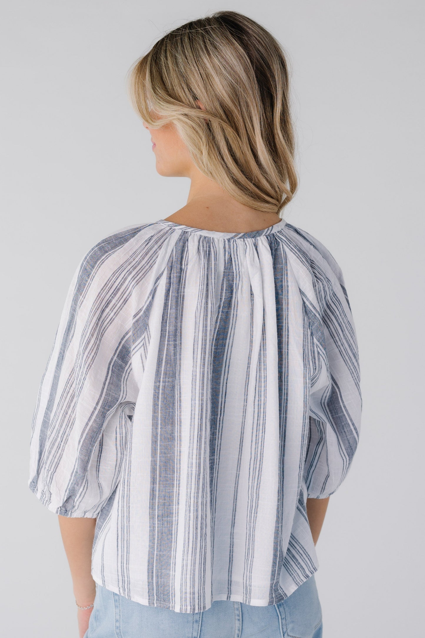Back view of blue and white stripe blouse