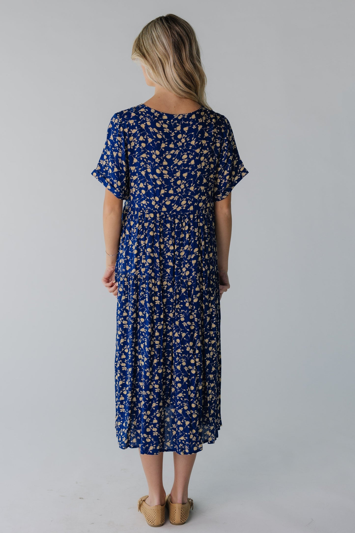 Back view of blue floral midi with short sleeves