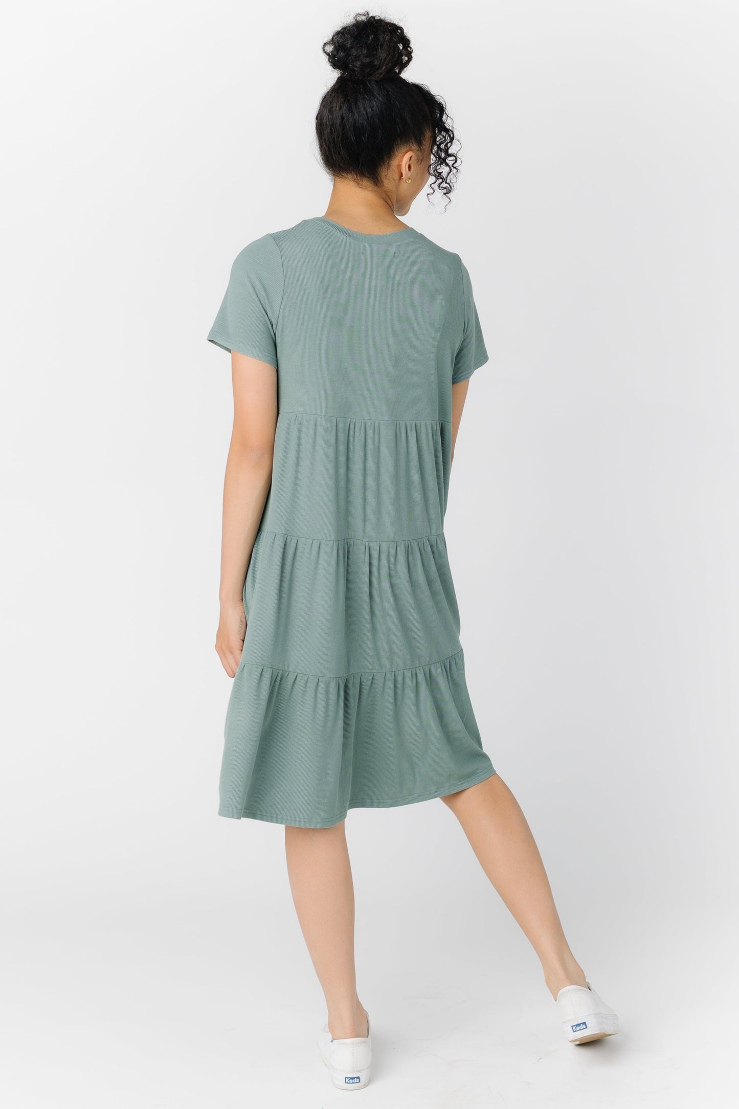 Back view of a woman wearing a seafoam green dress with short sleeves