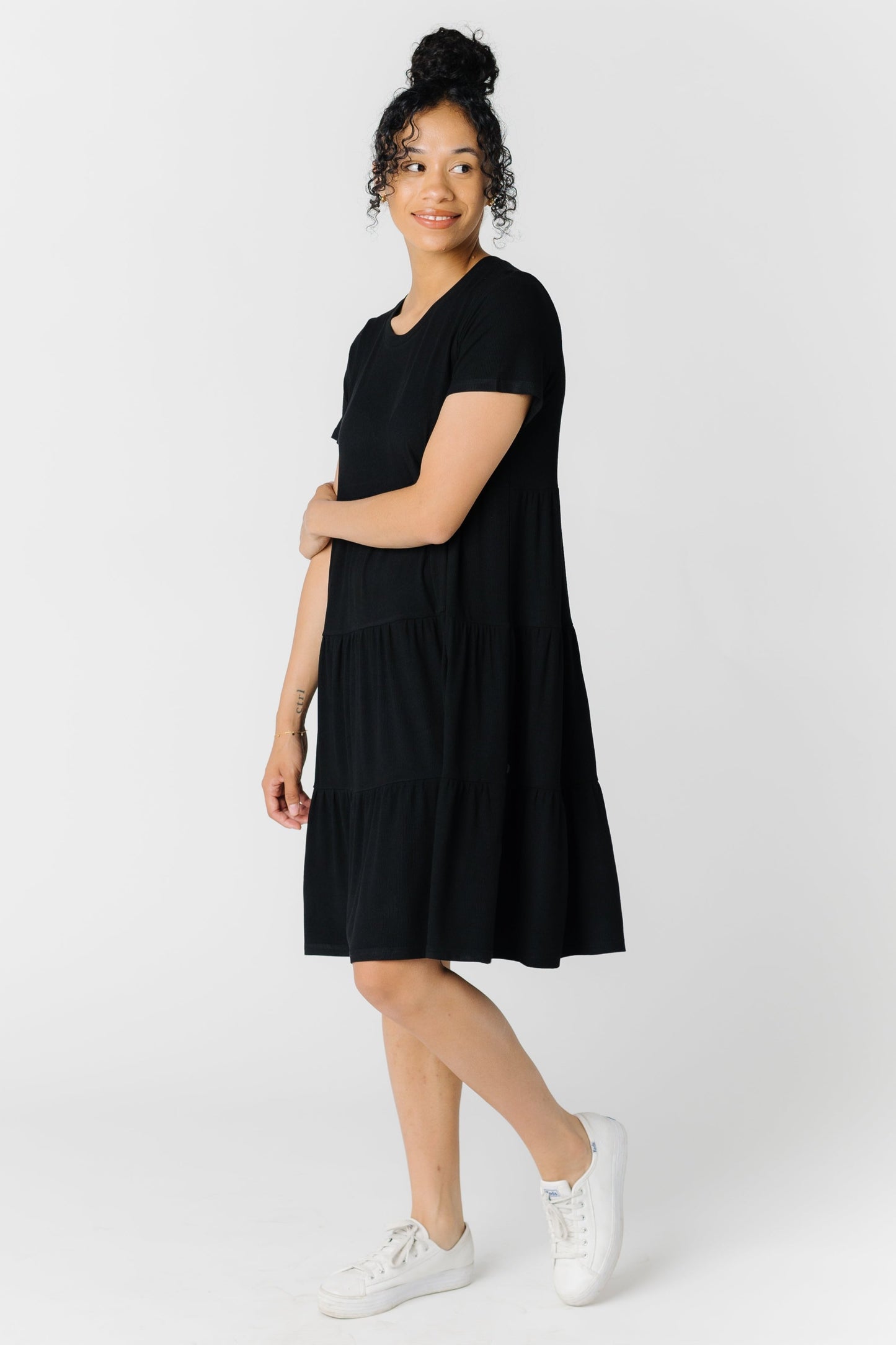 Modest women's black tiered dress with short sleeves