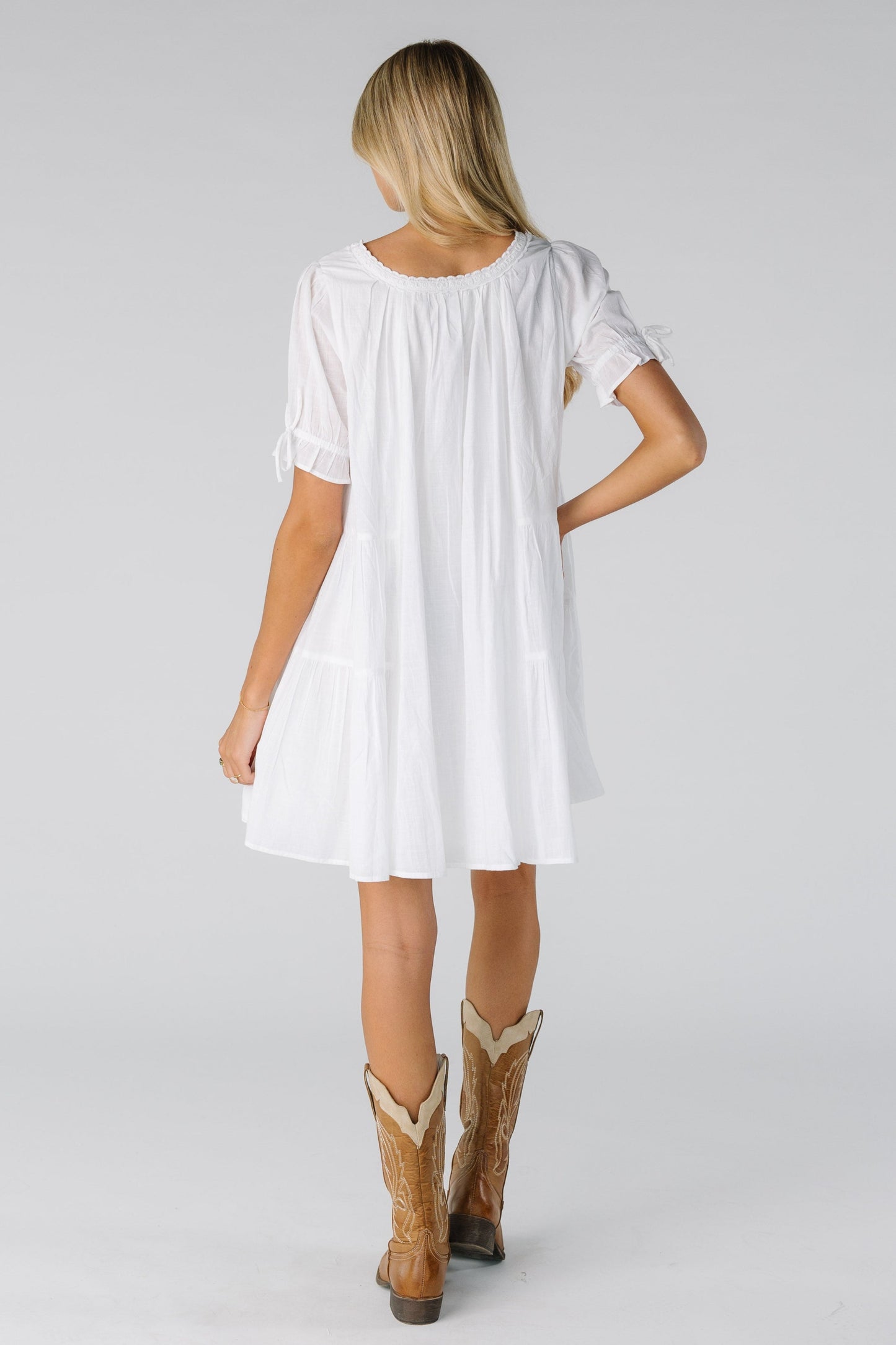 Back view of white knee length dress with short sleeves