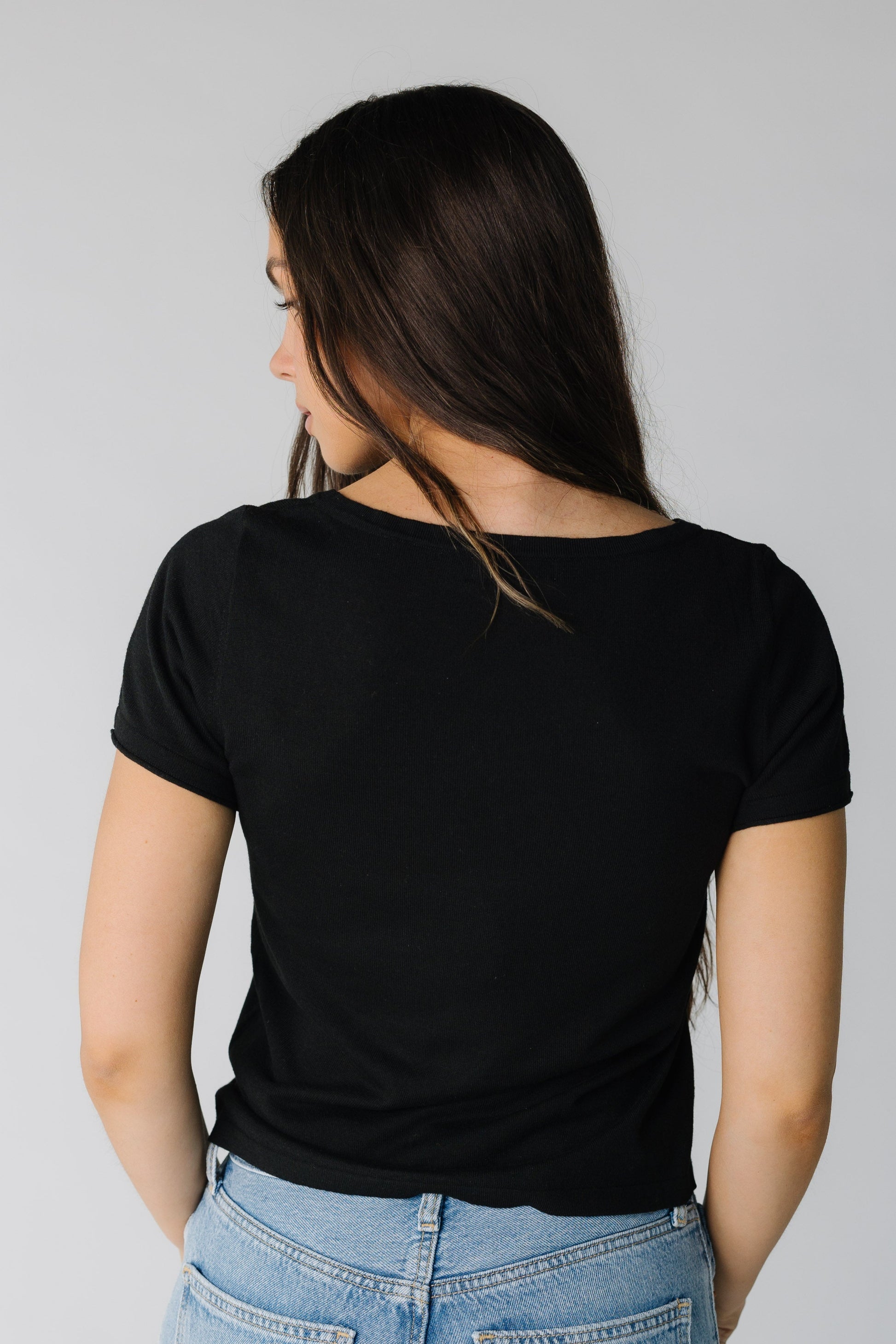 Back view of black short sleeve top