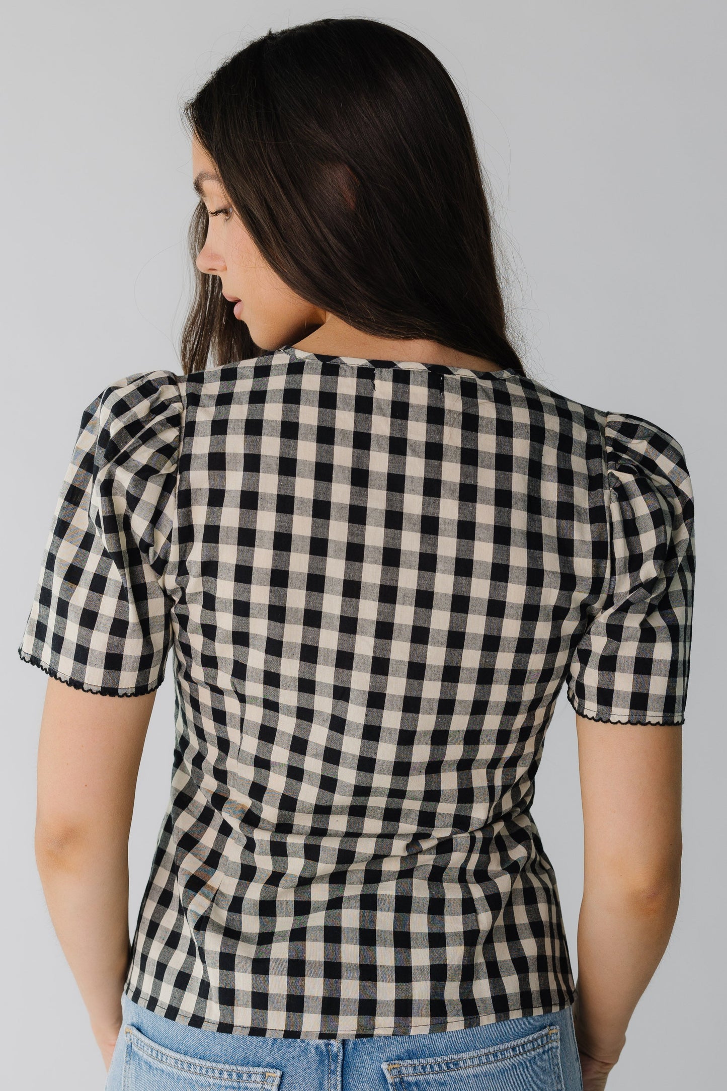Back view of black and cream short sleeve top