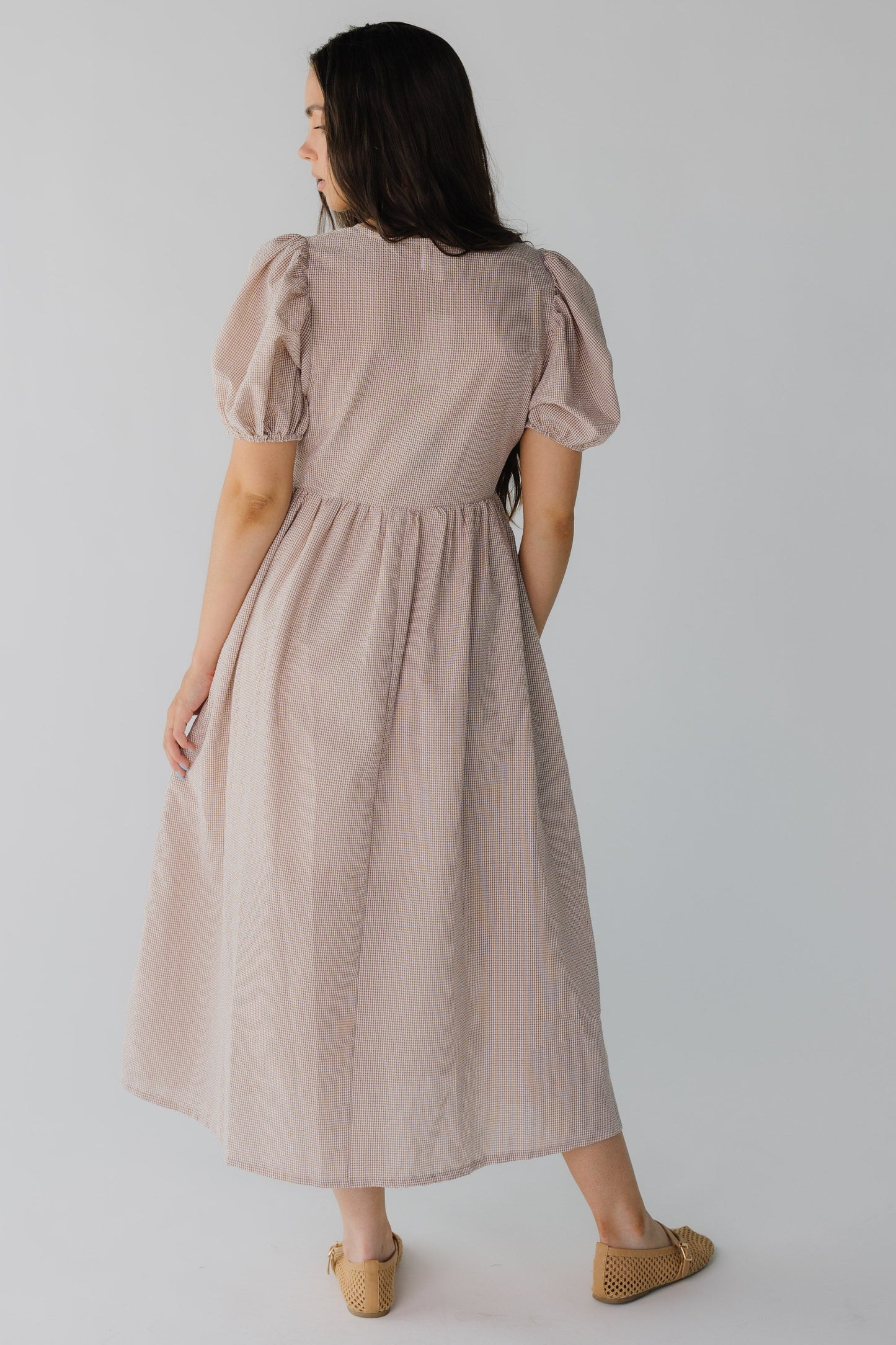 Back view of brown gingham midi dress with short puff sleeves