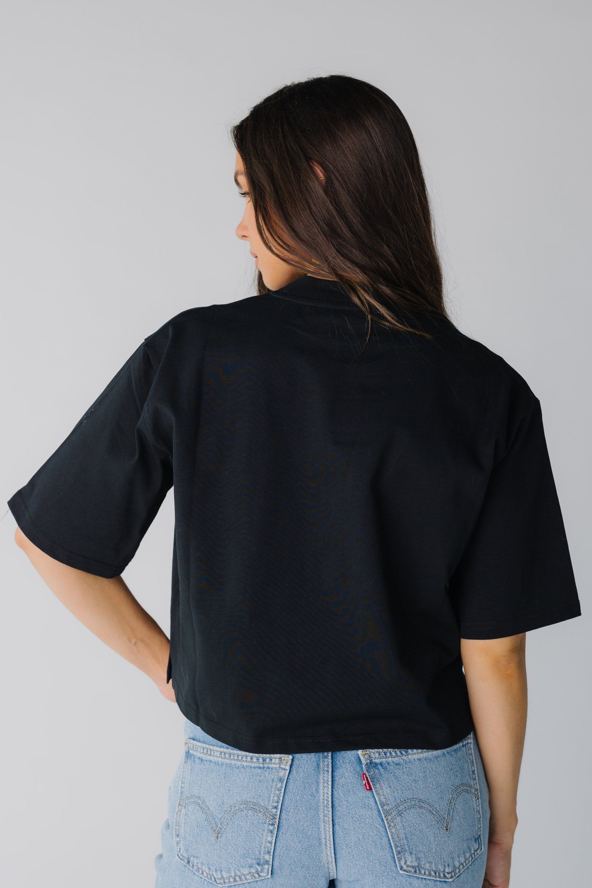 Back view of women's elbow length top in black