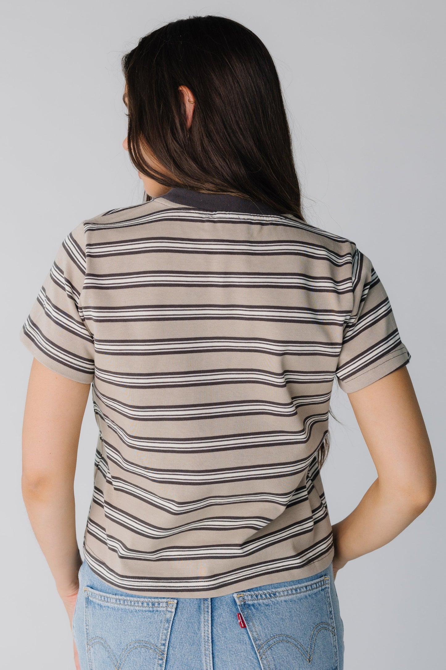Back view of women's brown stripe tee with short sleeves