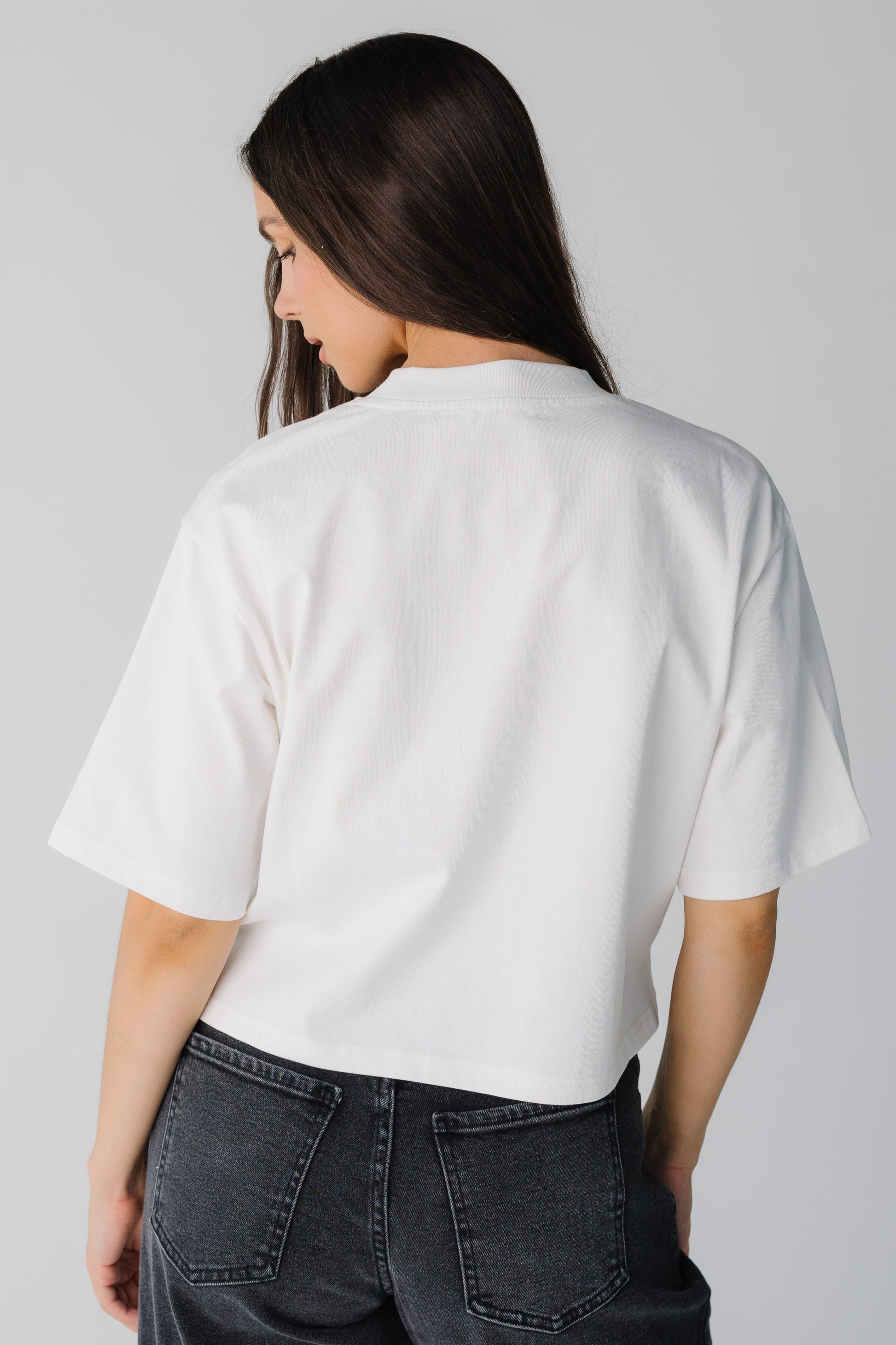 Back view of white women's top with elbow length sleeves