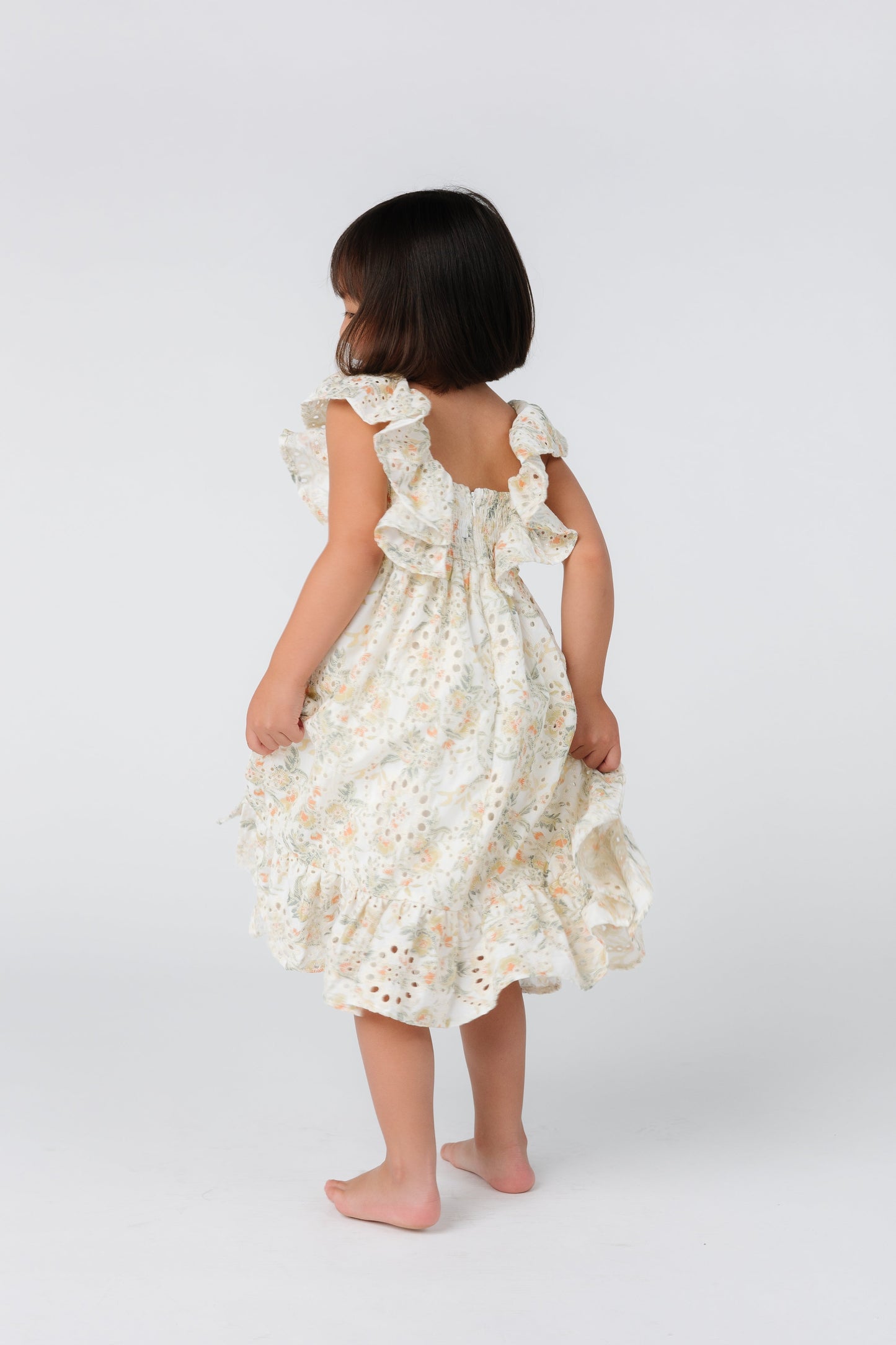Back view of floral eyelet dress with square neckline