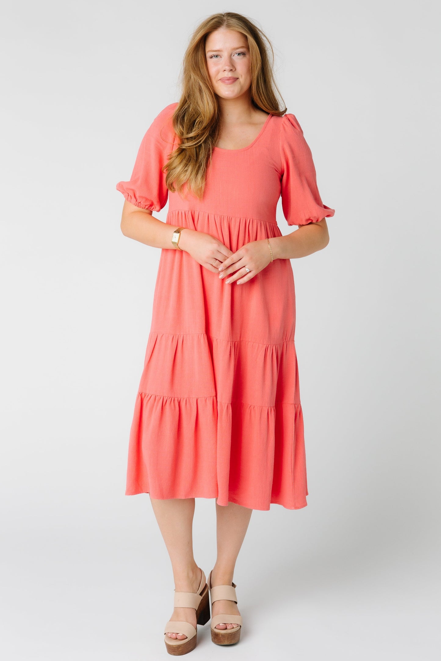 Lovely textured coral midi dress with scoop neckline and gathered tiers