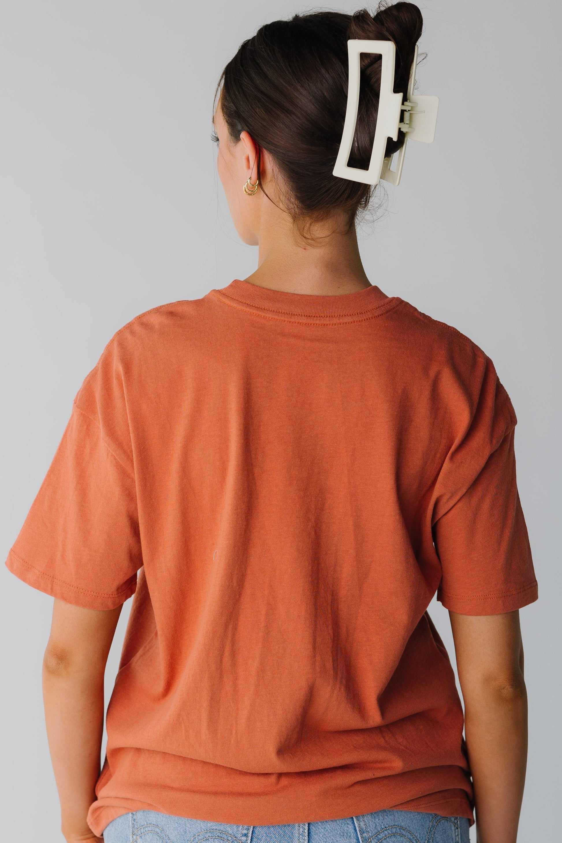 Back view of rust loose fitting tee with short sleeves