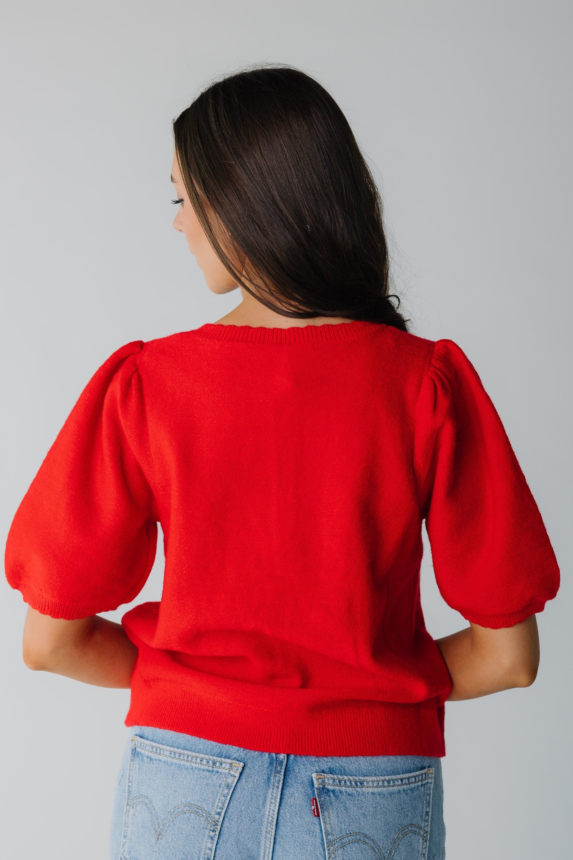 Back view of red sweater with elbow length sleeves