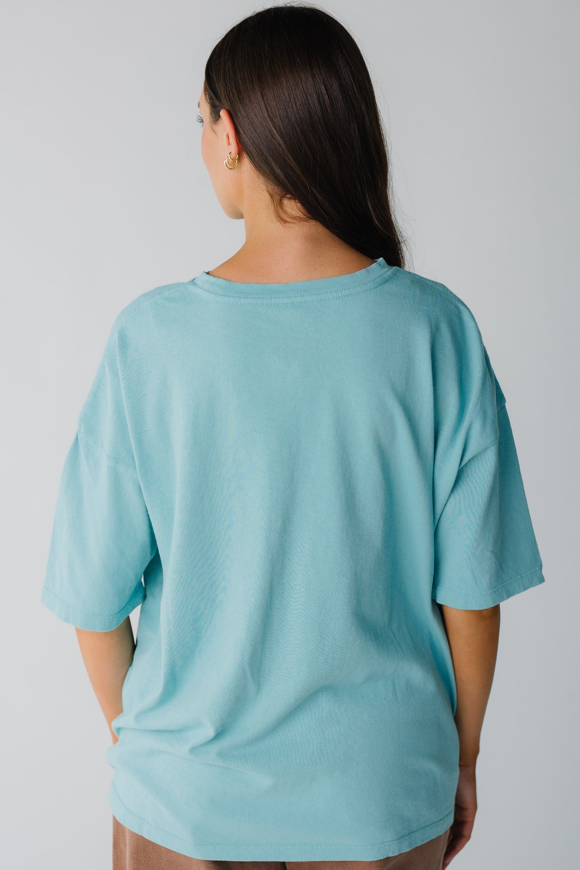 Back view of aqua loose fitting tee with short sleeves