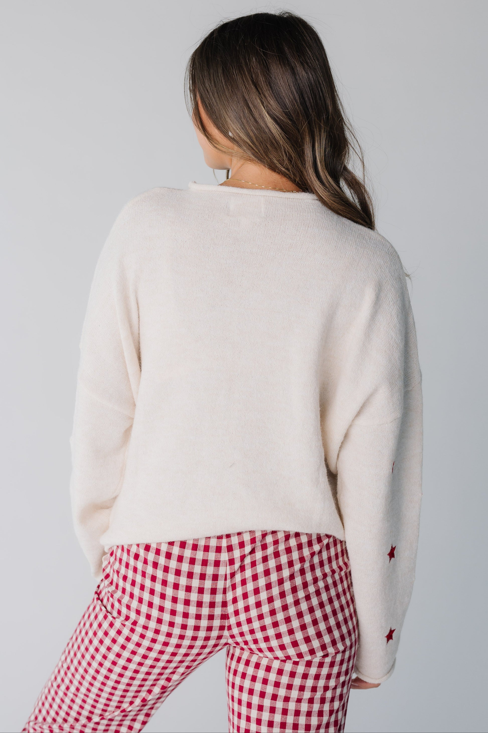 Back view of cream cardigan with long sleeves