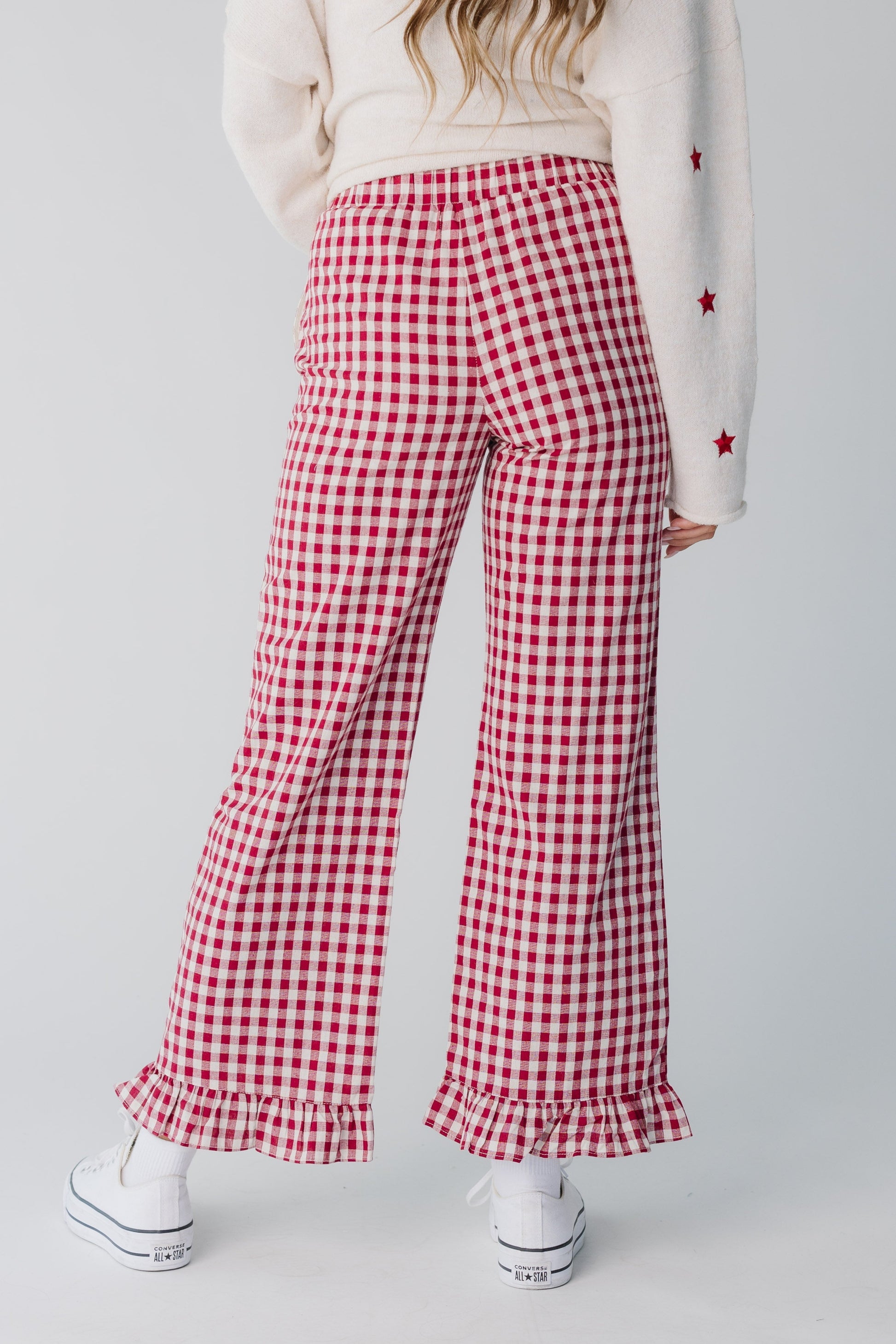 Back view of women's red gingham wide leg pant with bottom ruffle