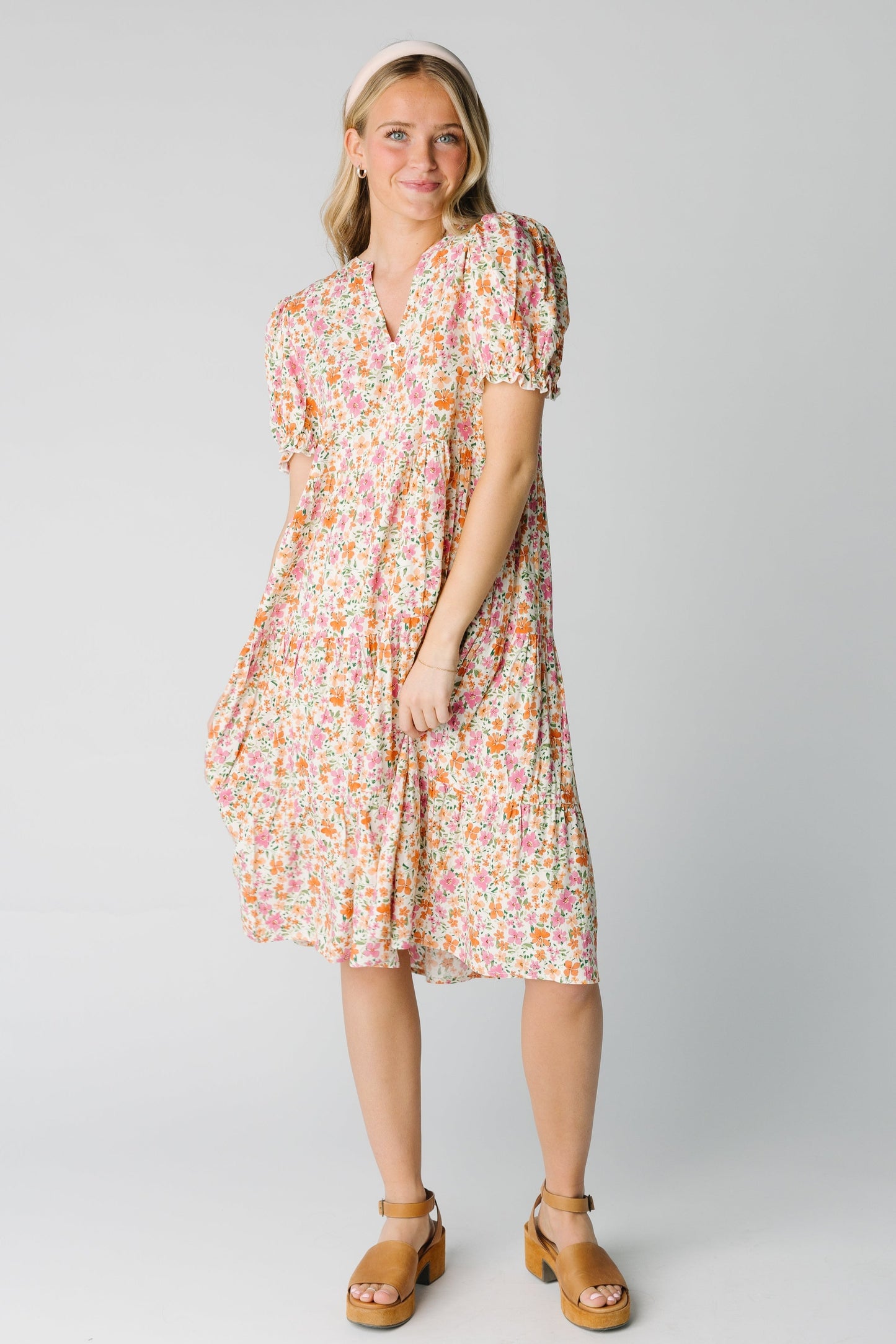 Modest women's pink floral dress with V-neckline and short sleeves