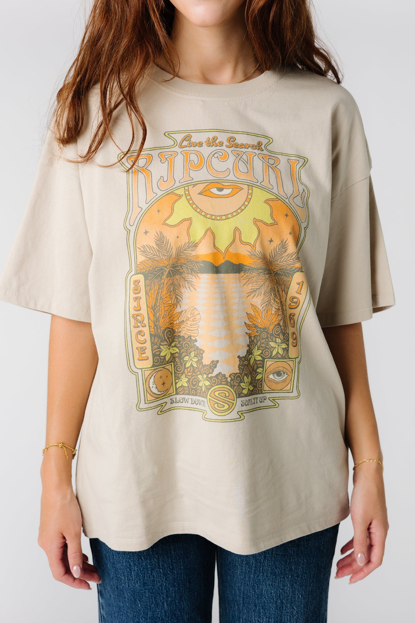 Close up view of tan Rip Curl Slow Down Heritage graphic tee