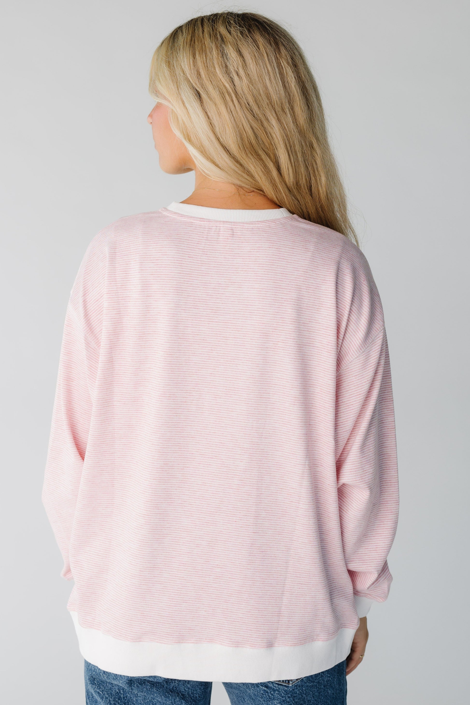 Back view of pink stripe sweatshirt long sleeve