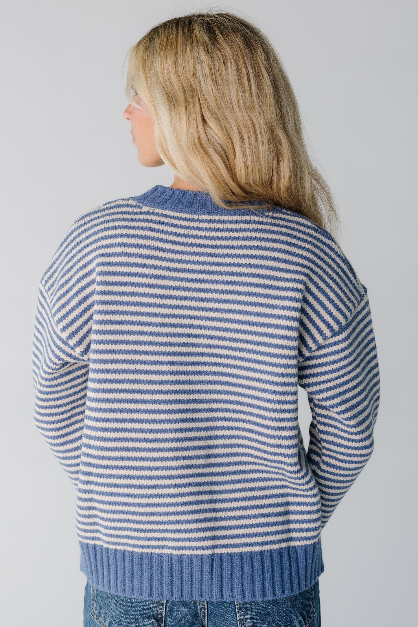Back view of blue and ecru stripe sweater