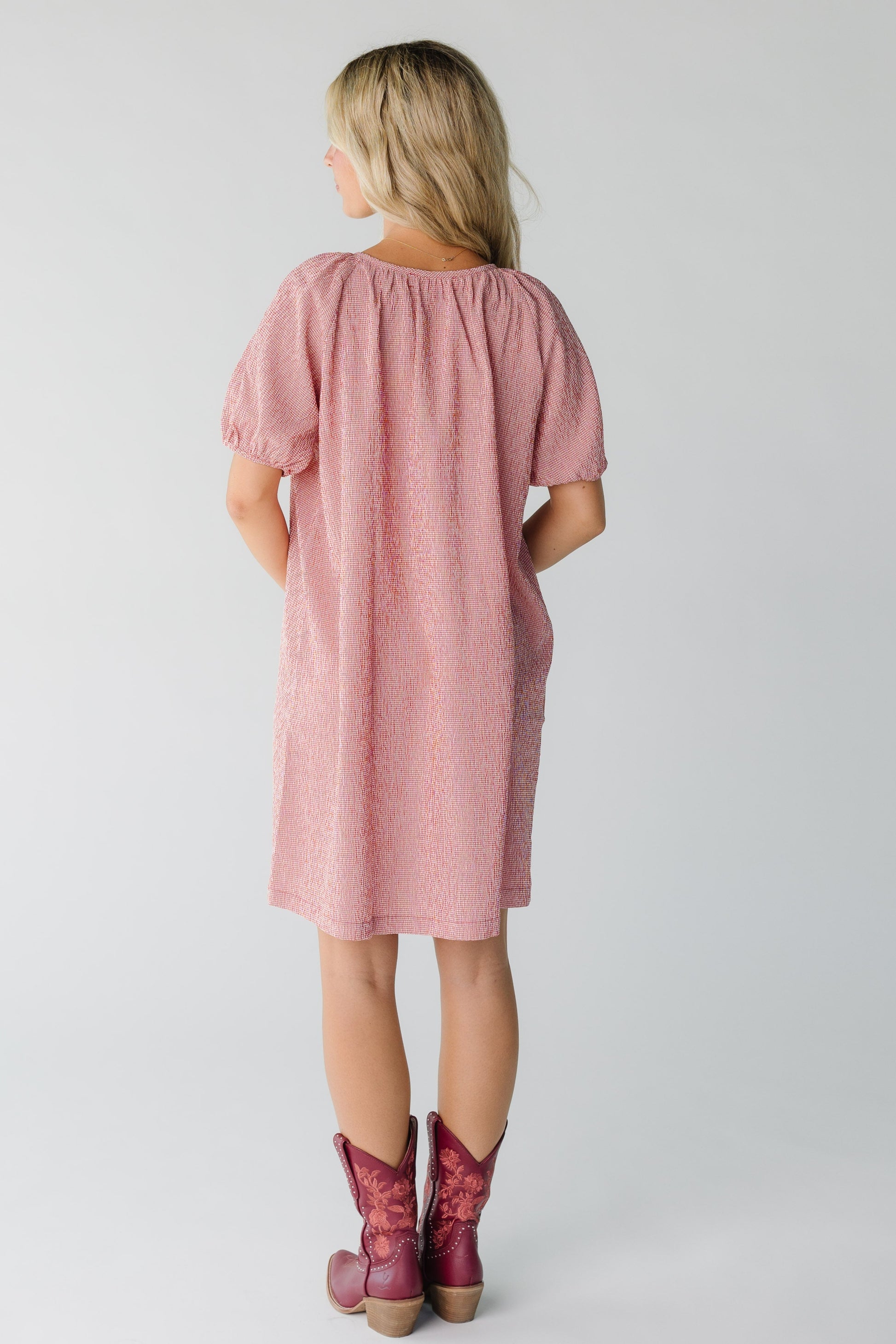 Back view of red gingham knee length dress with short sleeves
