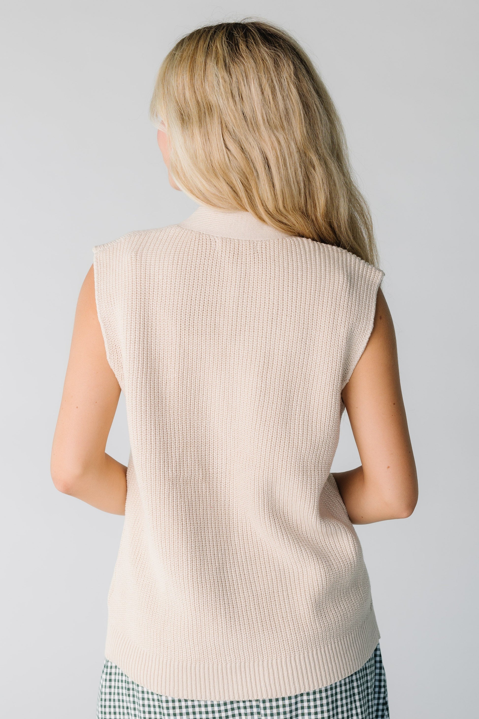 Back view of cream sweater vest